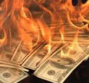 Money on fire representing wasted merchant processing fees — Utah businesses lose thousands annually paying Toast, Square, Clover and Shift4 rates instead of using Genius POS Dual Pricing