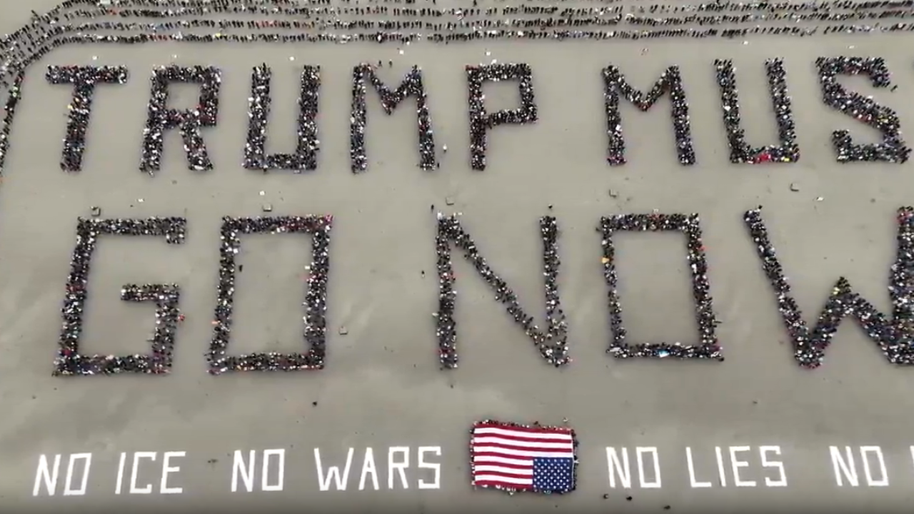 Hundreds Form Human Banner at San Francisco’s Ocean Beach to Protest President Trump