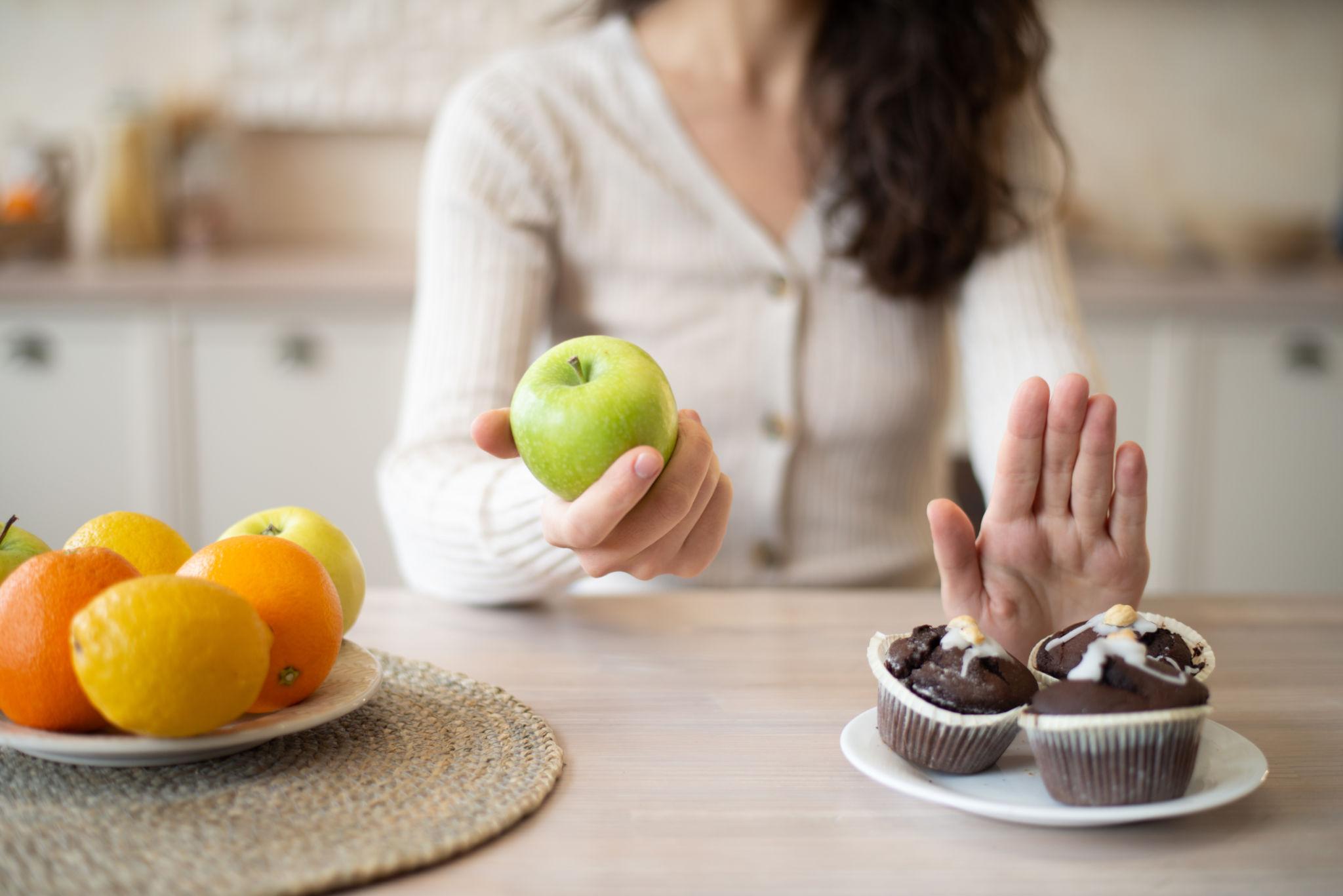 a woman choosing food over cravings