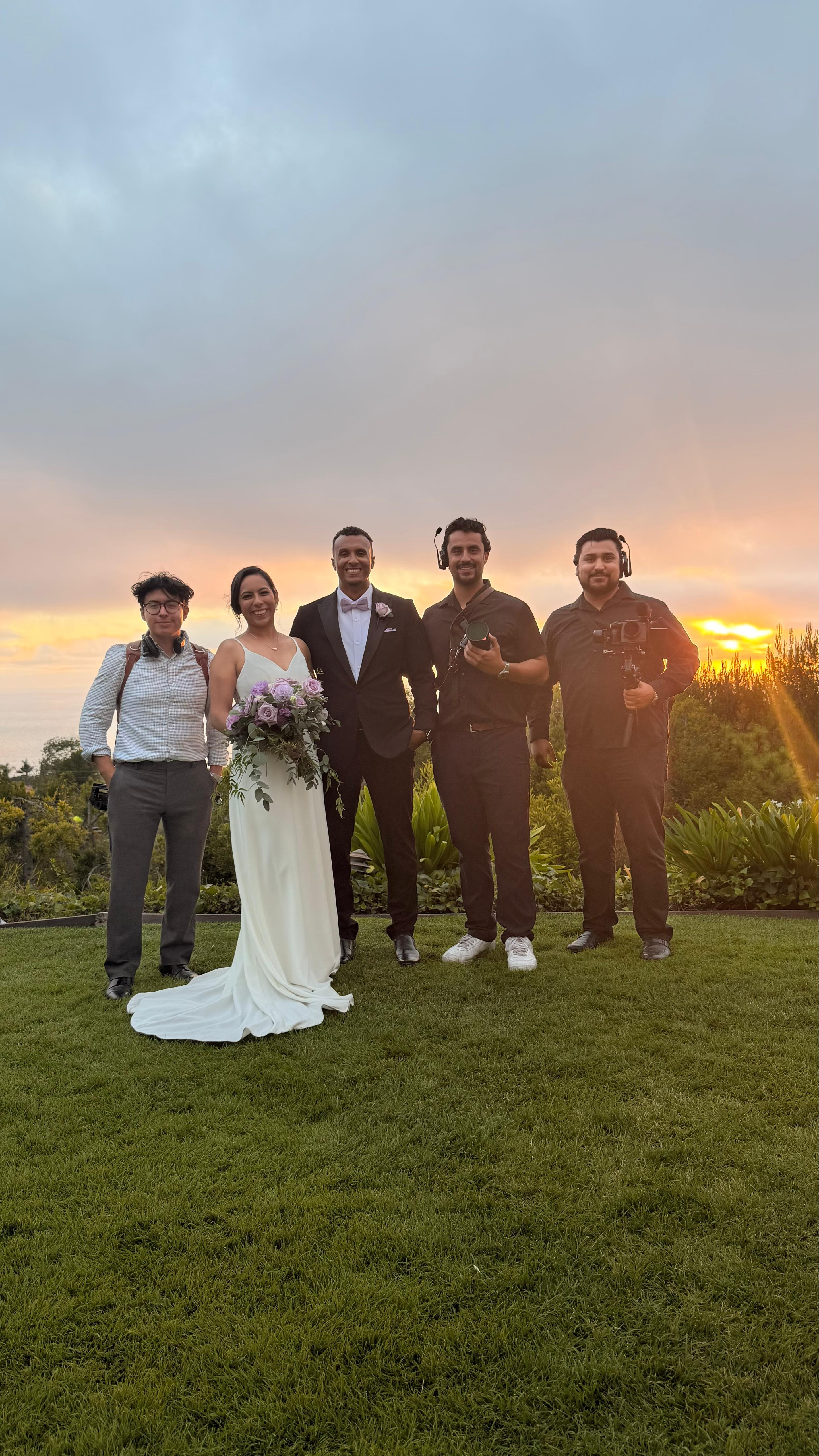 Wedding couple and camera crew at sunset