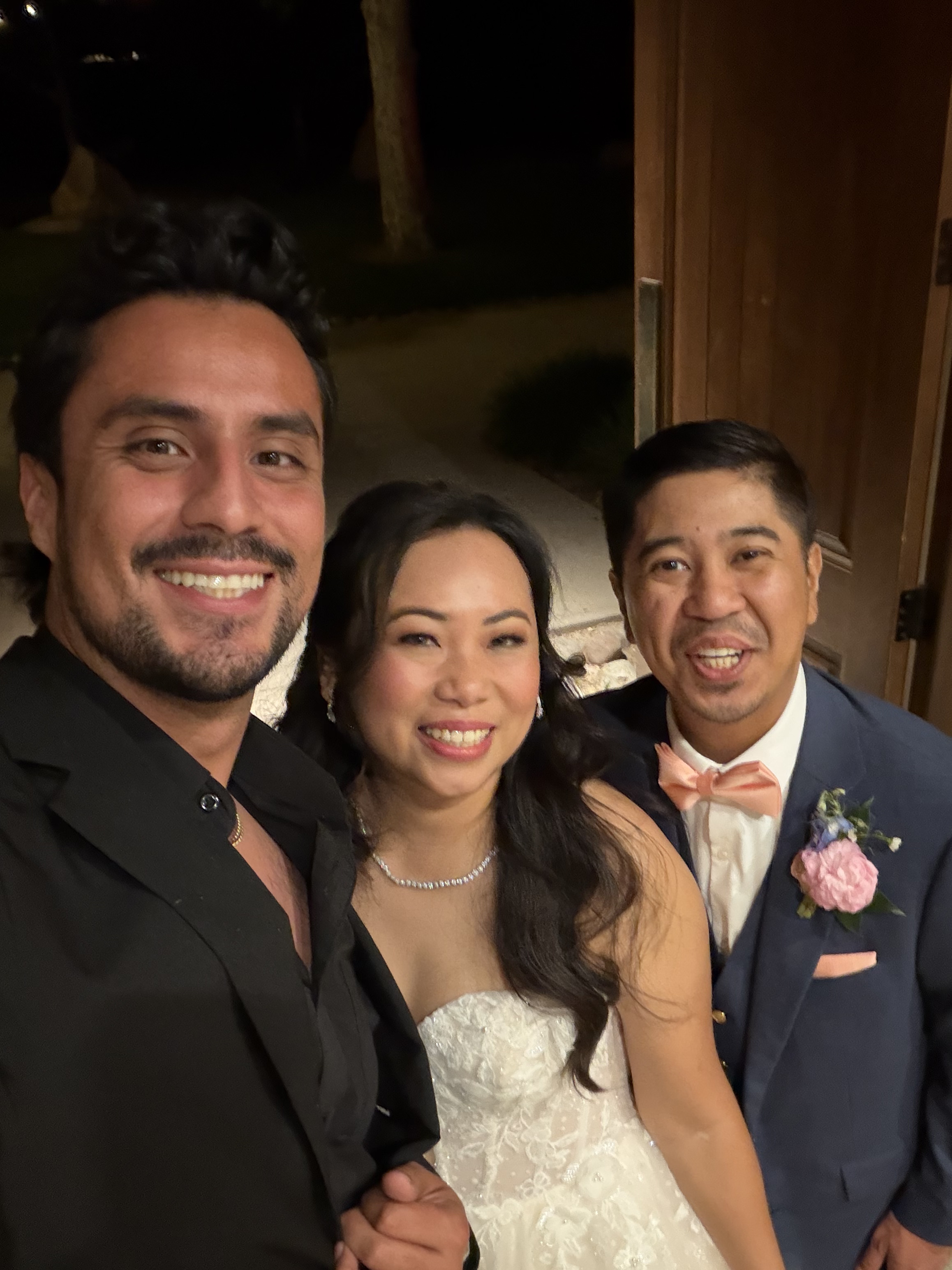 Aram with a bride and groom indoors