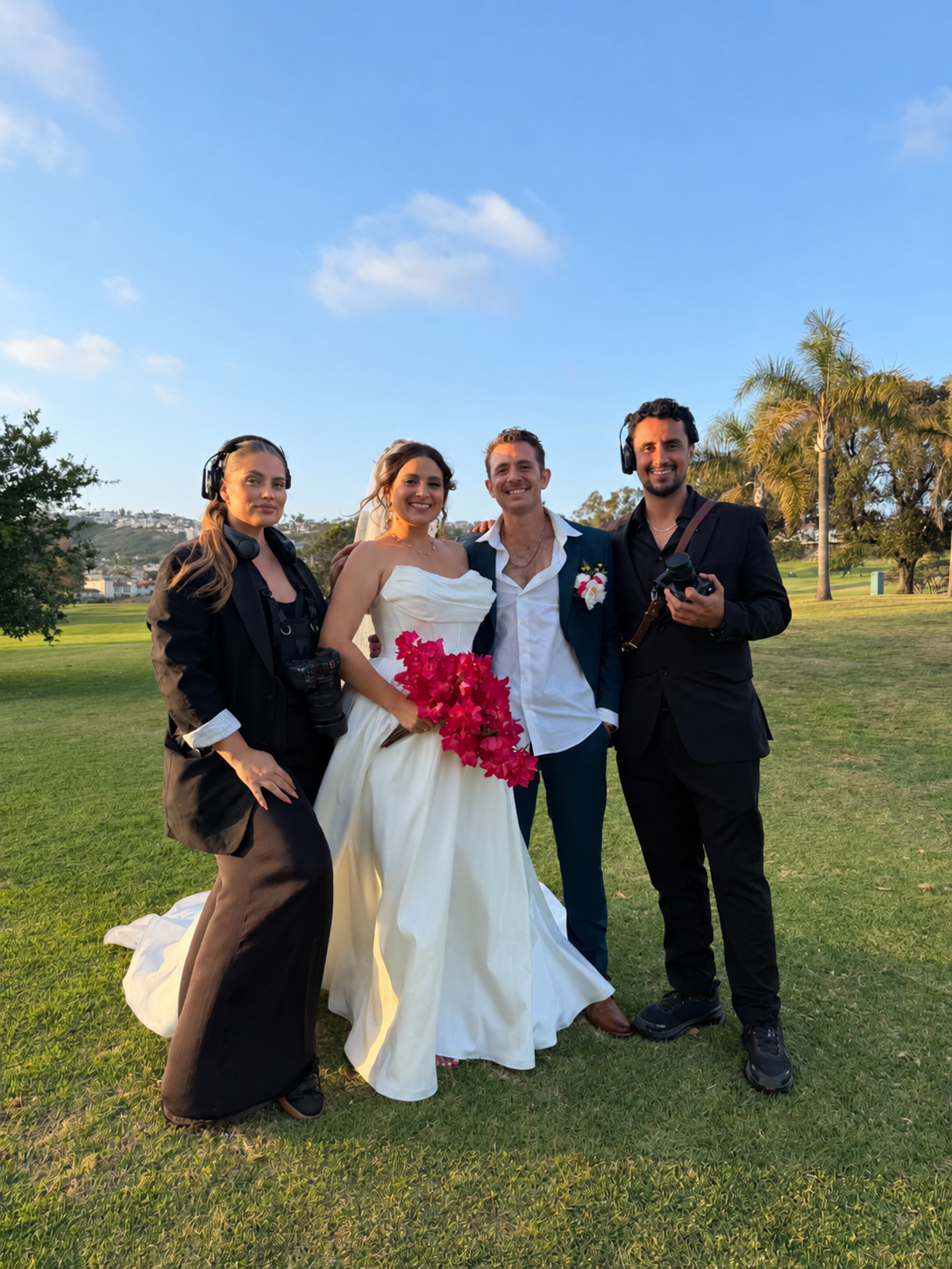 Wedding couple with their filmmaking team outdoors