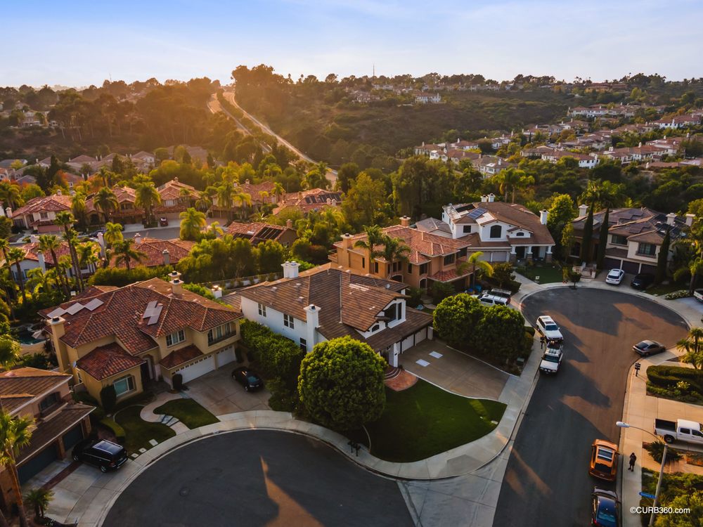 Contractor repairing plumbing in a San Diego rental while manager reviews costs