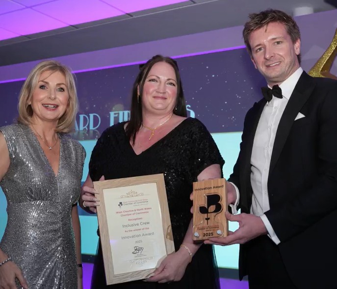 phillipa on stage being presented with her award of a wooden trophy and certificate