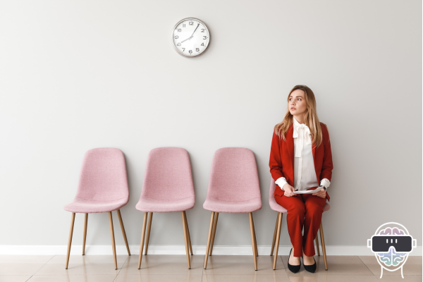 lady sitting on a chair in a row of empty chairs with a clock on the wall nervously waiting for an interview