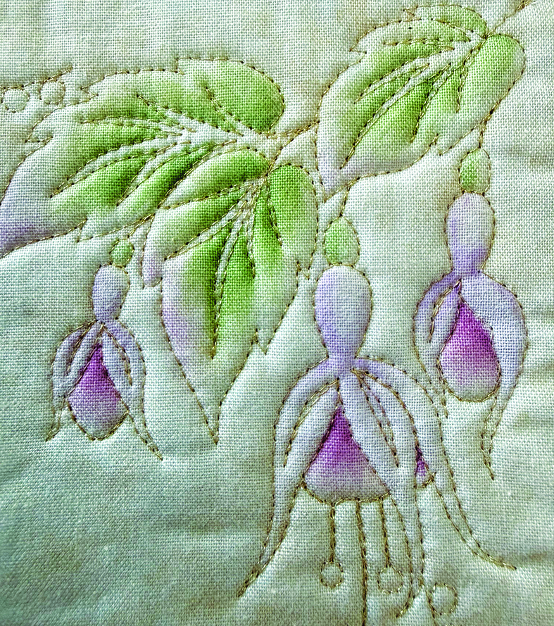 Two hummingbirds embroidered around purple foxglove flowers