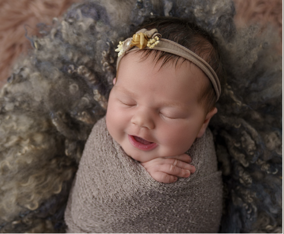 Newborn sleeping and smiling