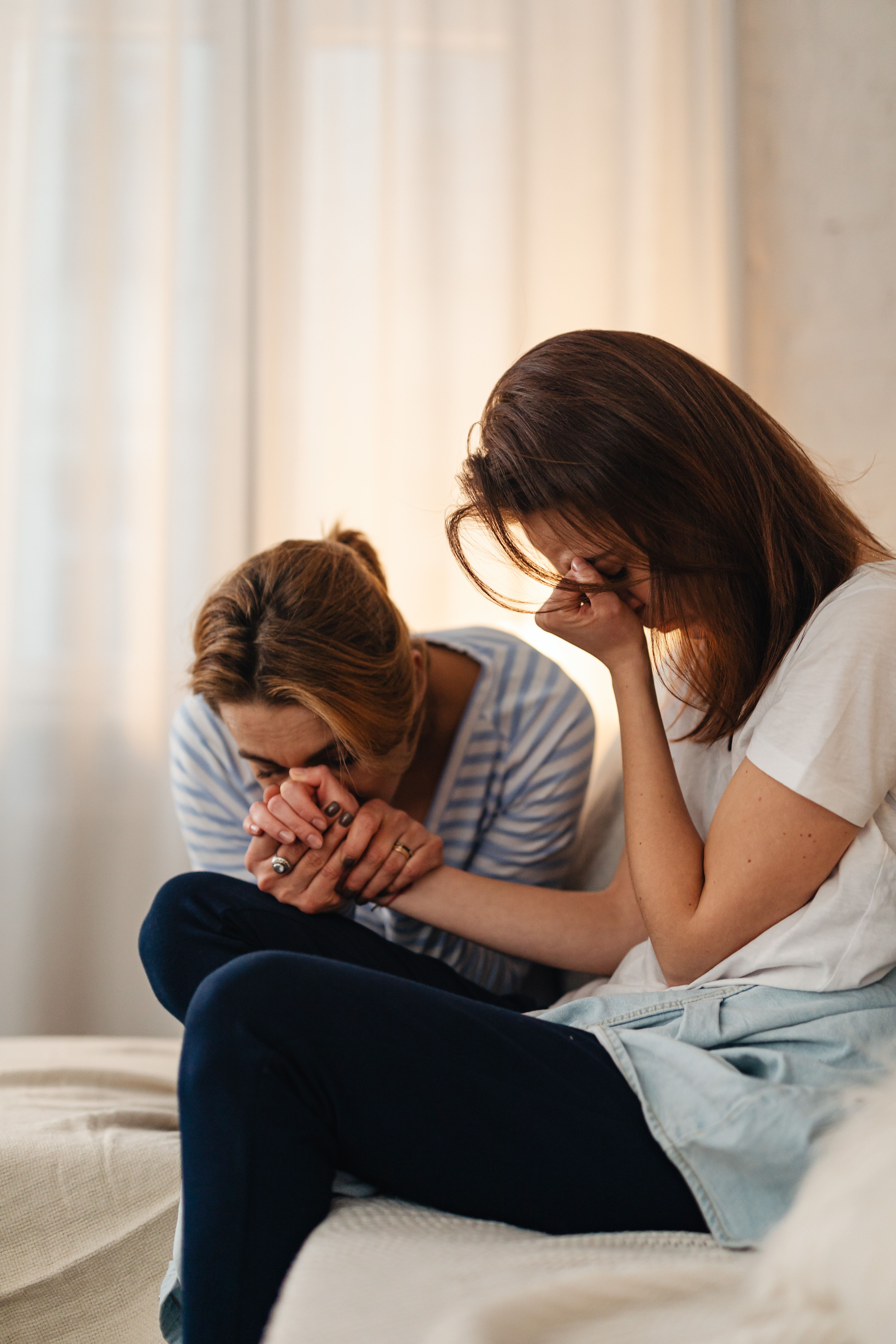 Christian parent and teenage child praying together while holding hands, demonstrating faith, emotional support, encouragement, and the power of speaking life and hope into children during difficult seasons. Christian parent and teenage child praying together while holding hands, demonstrating faith, emotional support, encouragement, and the power of speaking life and hope into children during difficult seasons.