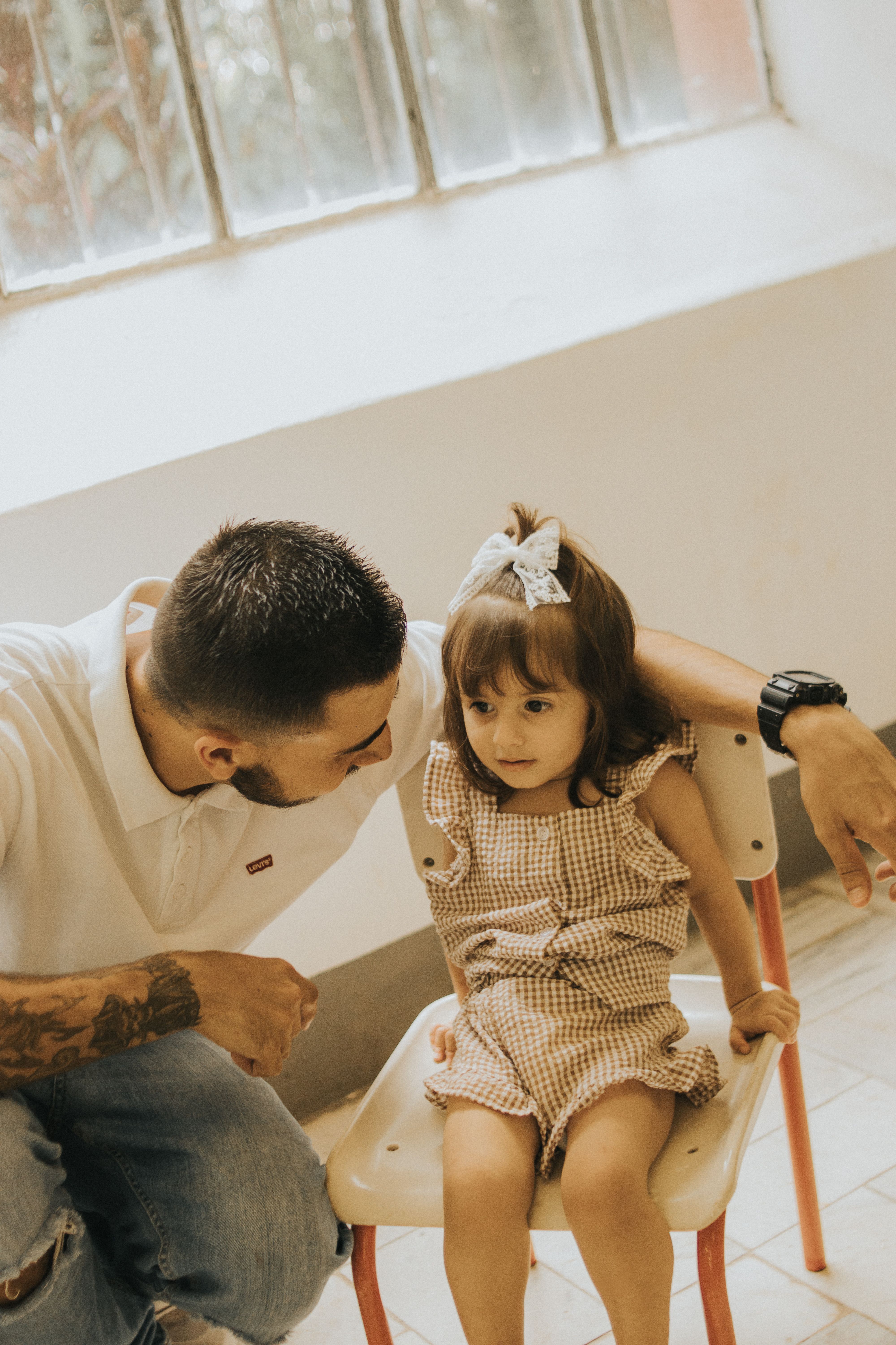 Christian father listening attentively to his young daughter during a heartfelt conversation, demonstrating patient parenting, emotional connection, trust-building, and biblical family communication.