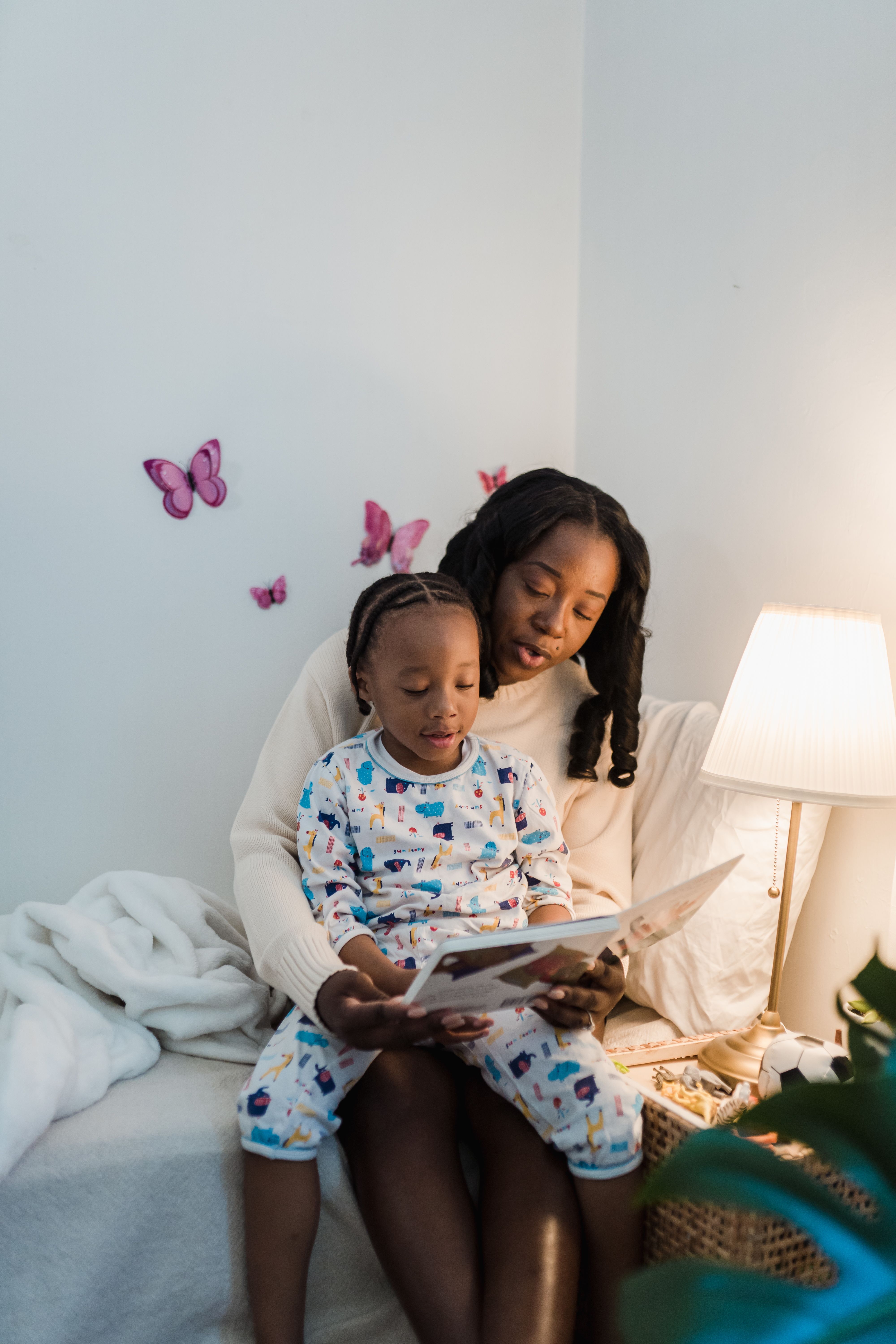 Christian mother reading a bedtime story with her young daughter in a cozy bedroom, creating a calm and peaceful moment of connection, love, and family bonding. Christian mother reading a bedtime story with her young daughter in a cozy bedroom, creating a calm and peaceful moment of connection, love, and family bonding.