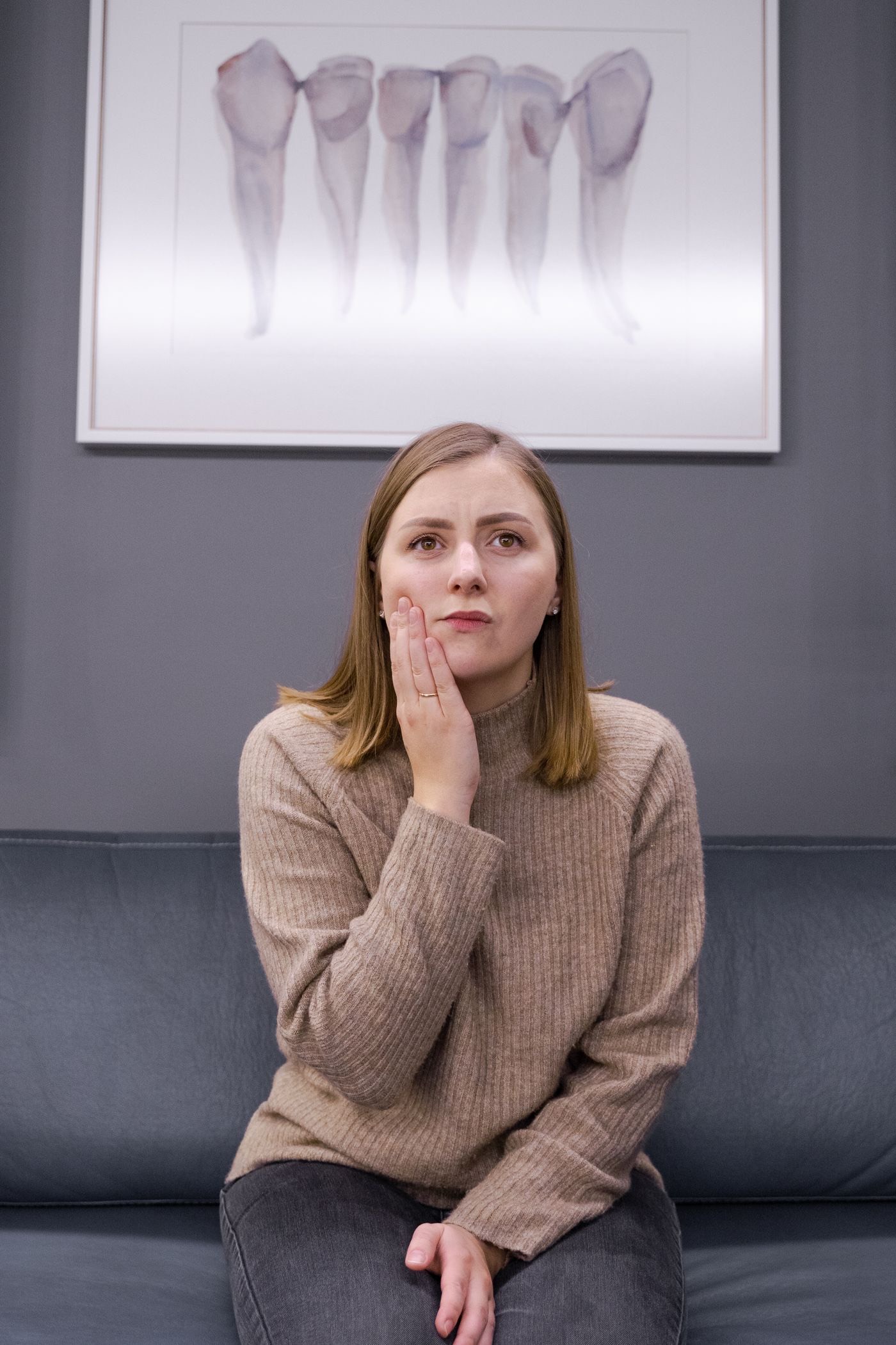 Woman holding her sore jaw