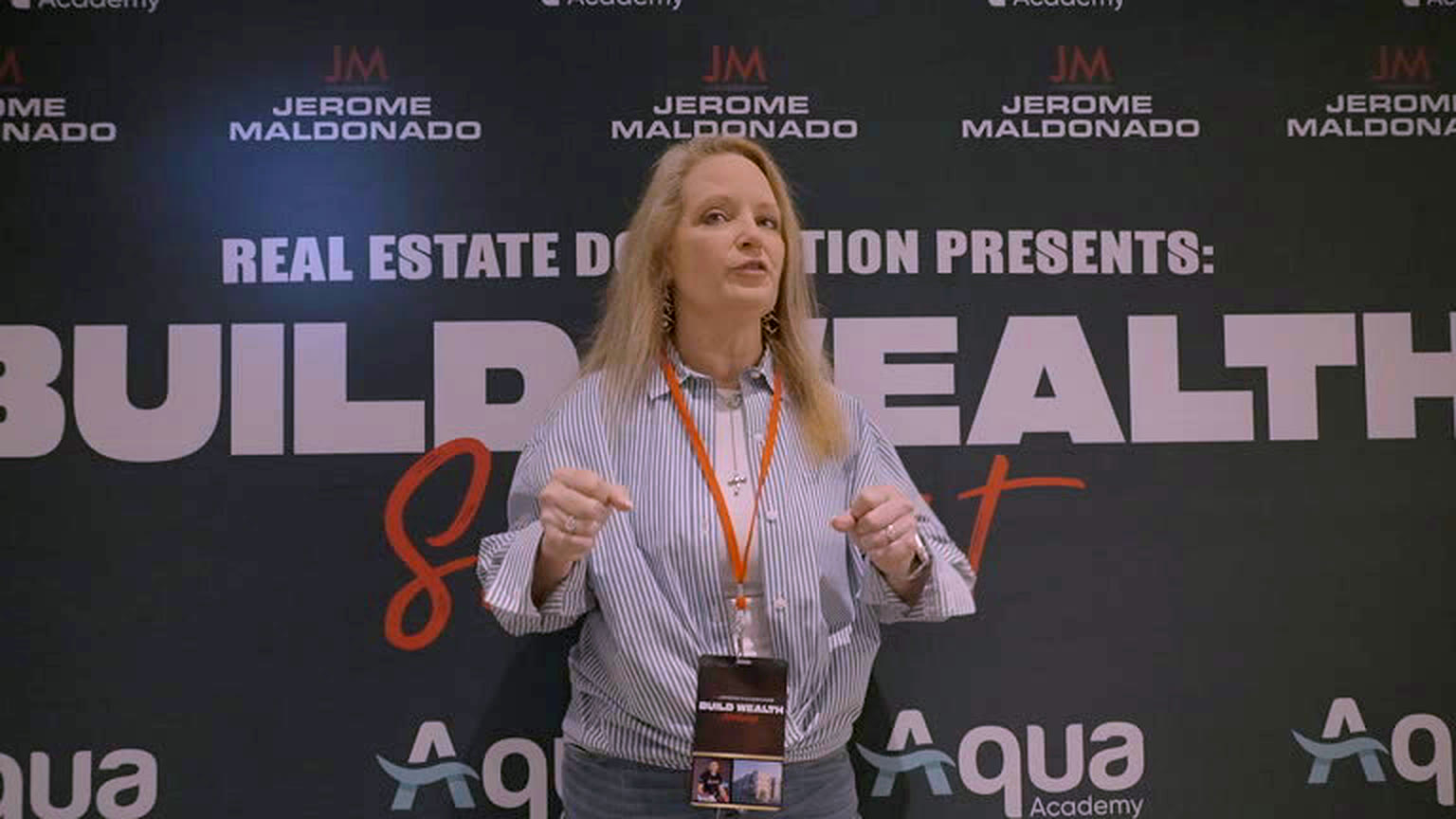 Speaker addressing the room at Build Wealth