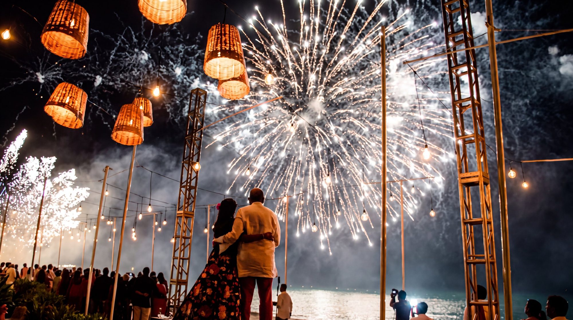 A bride and groom watching fireworks above their wedding reception