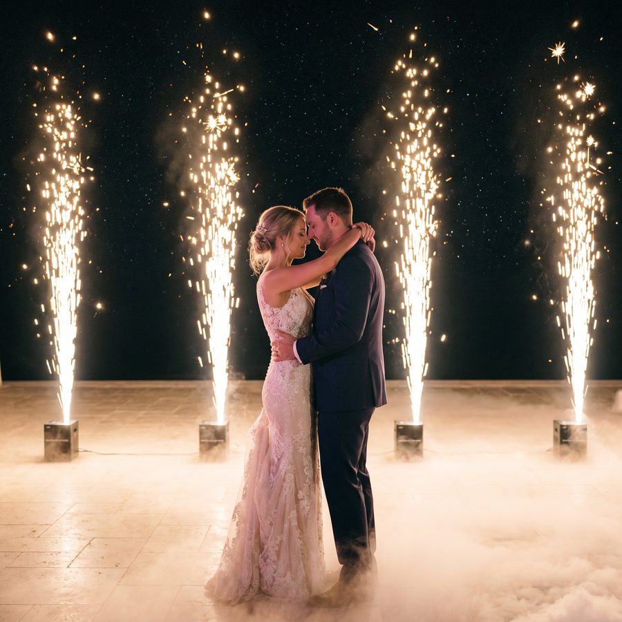 Cold spark fountains around a couple in a ballroom
