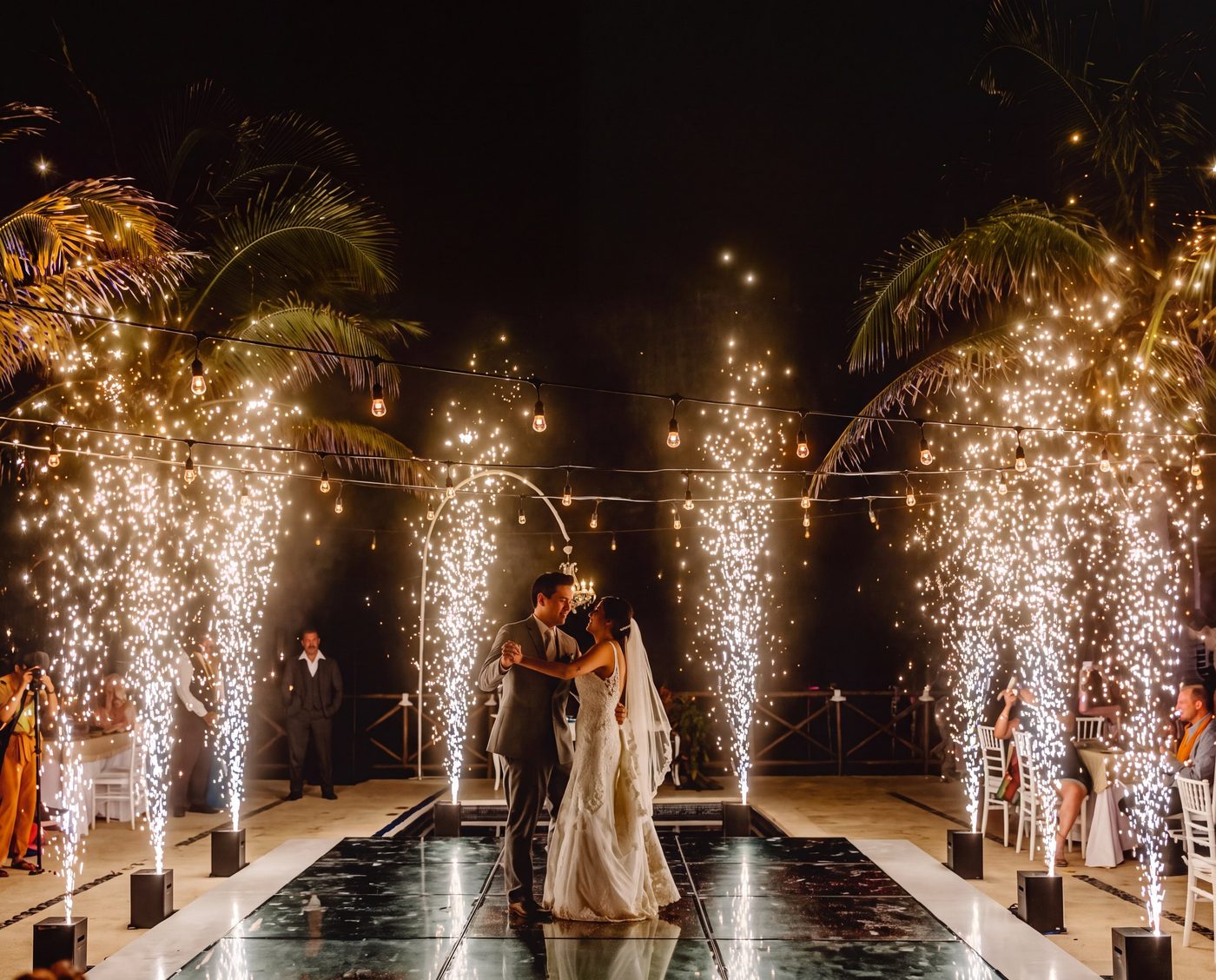 Cold sparks rising around a couple during their first dance at a real wedding