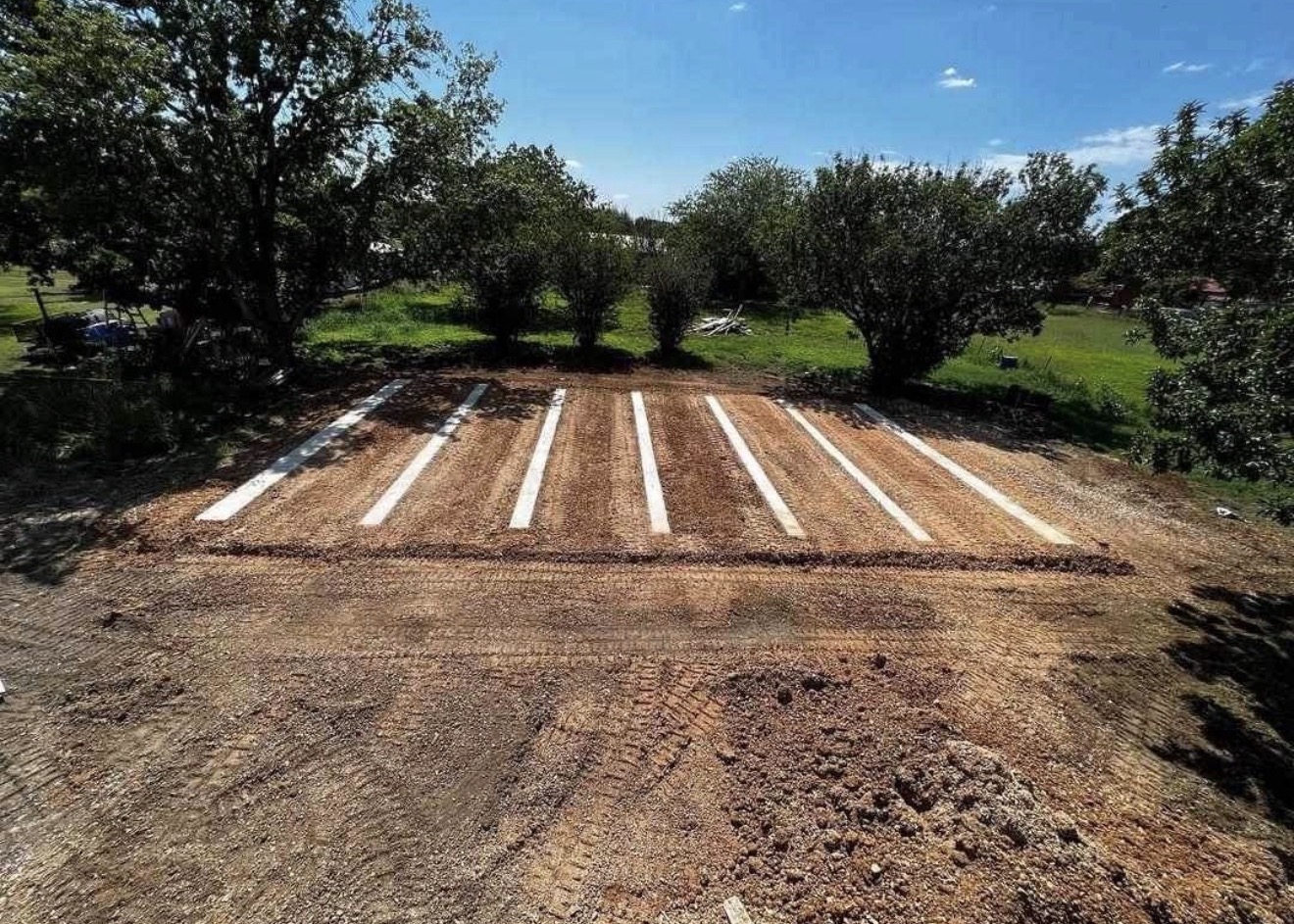Land improvements including caliche base pads and concrete runners
