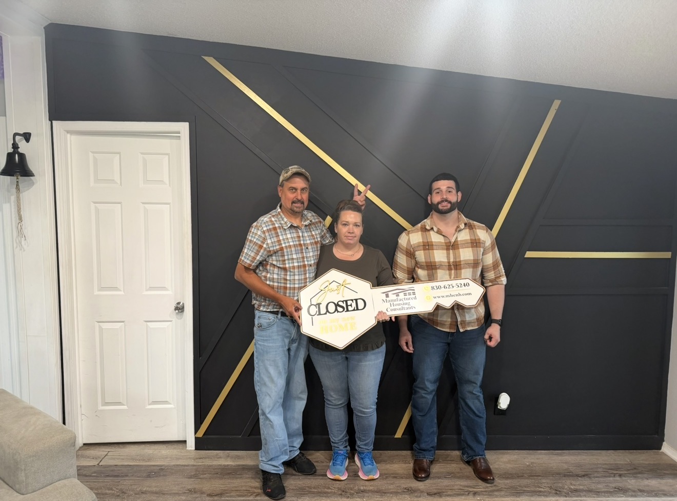 Nathan Guidry with a husband and wife celebrating the closing on their new manufactured home in Texas