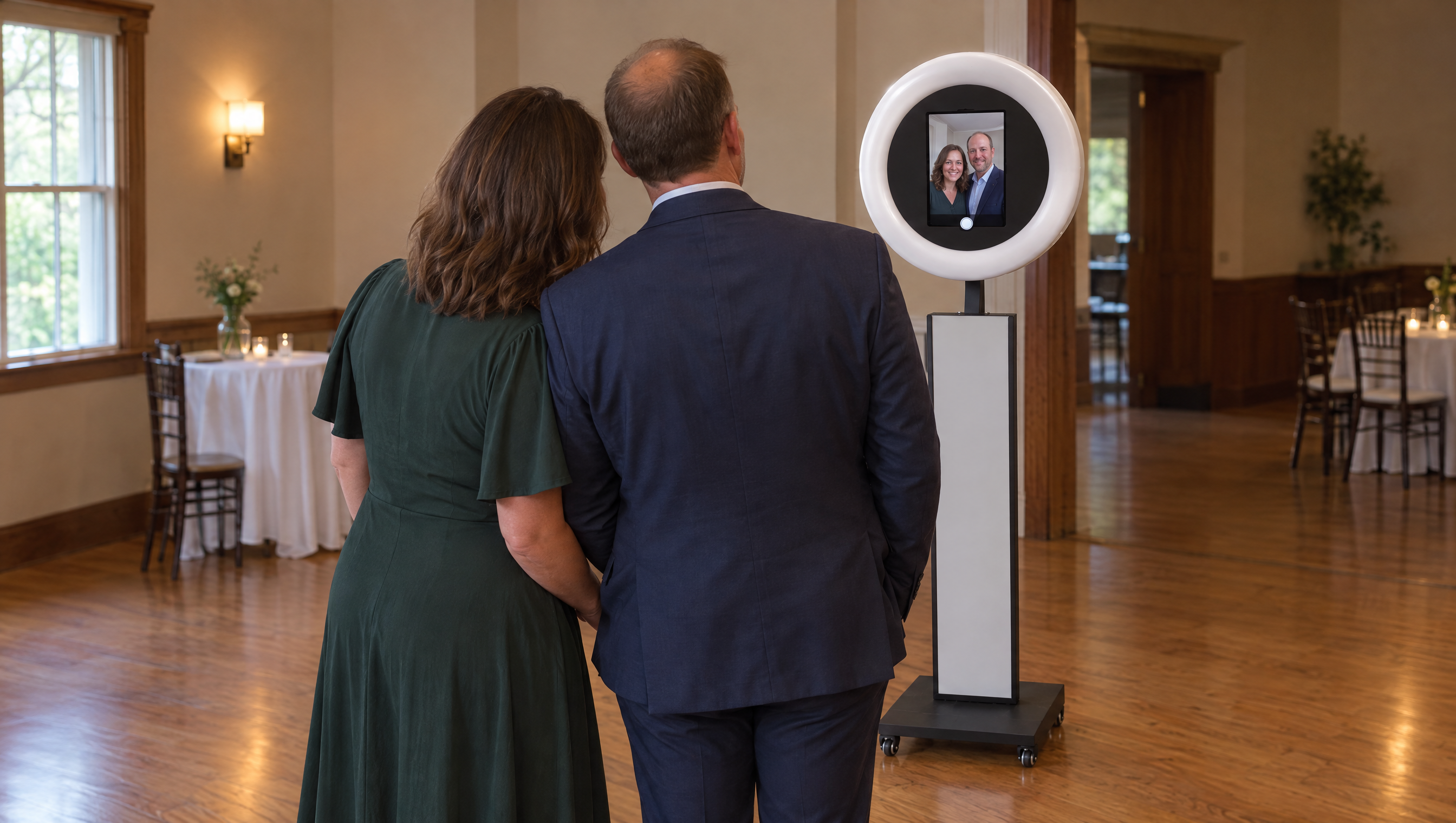 AI event mockup of fictional adult wedding guests facing the Mobile Booth and its active screen.