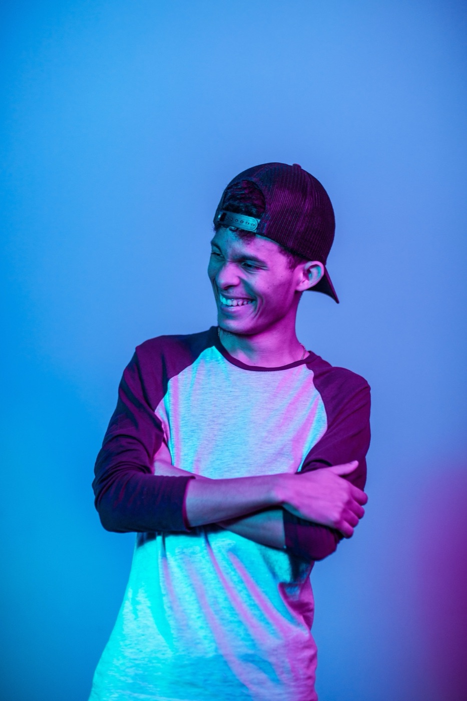 Guest laughing in electric blue and pink booth lighting