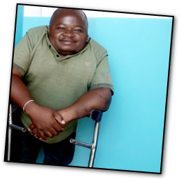 African man with dwarfism receiving support through Little People of Africa Foundation.