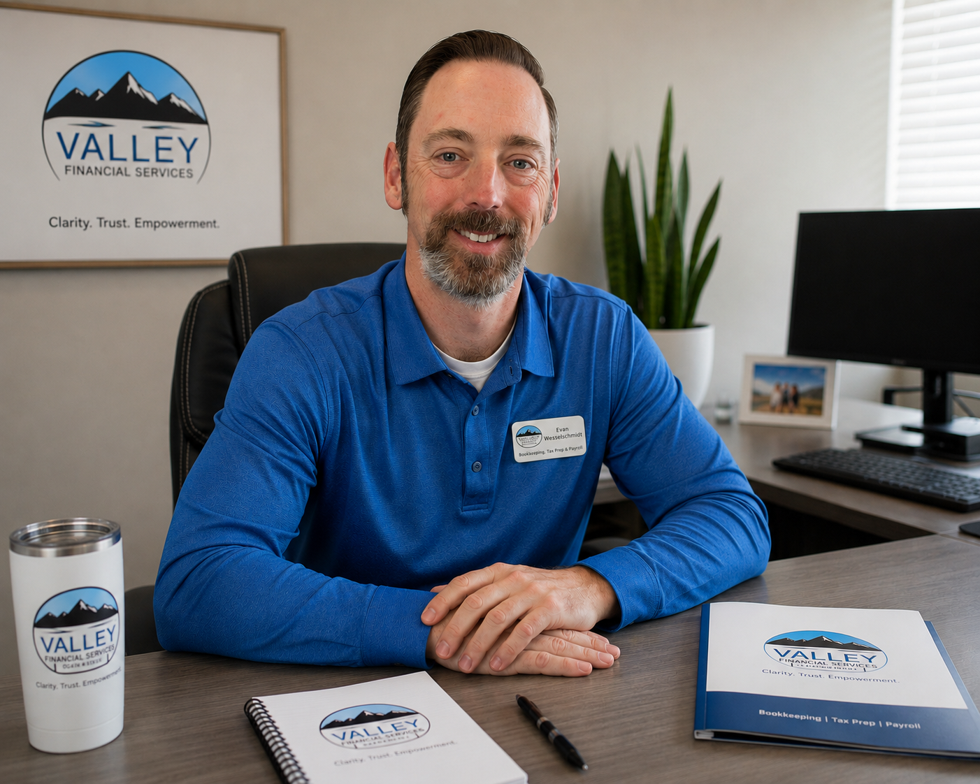 Evan from Valley Financial Services seated at his office desk