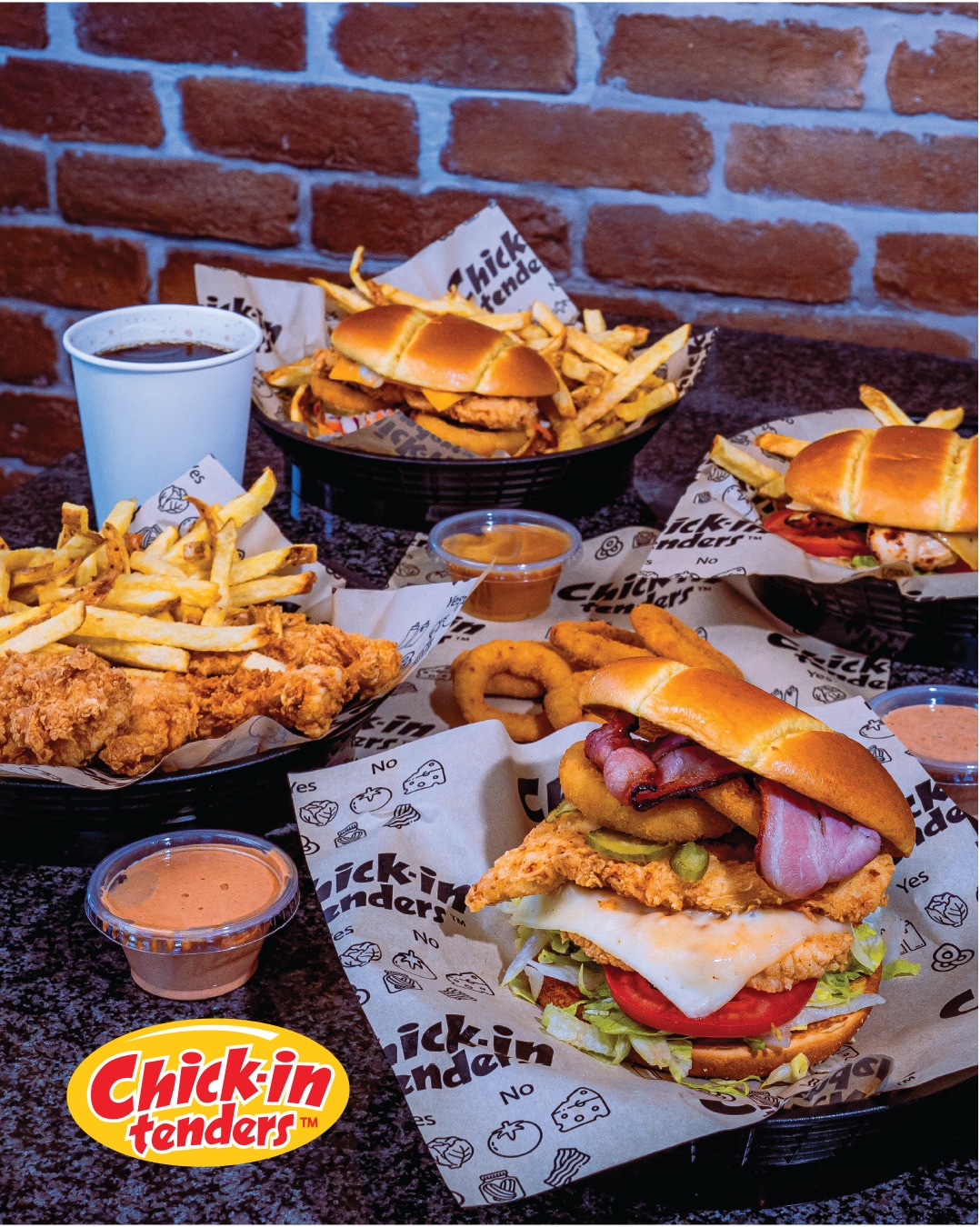 Chick-in Tenders table spread with burgers, fries, tenders and sauces