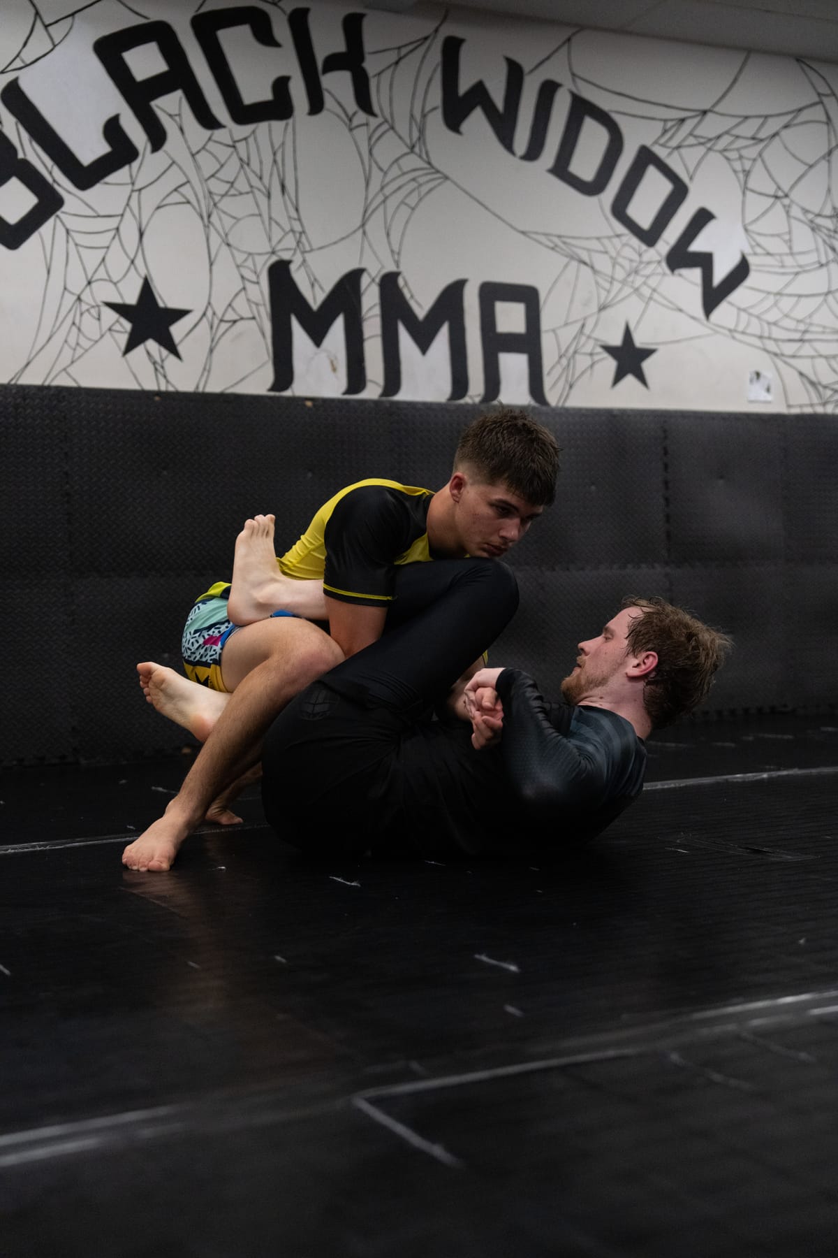 Training at Black Widow MMA - grappling with branded wall