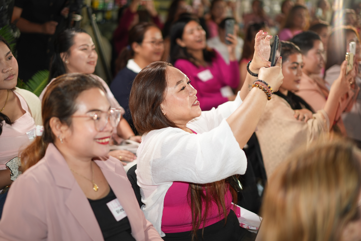 Attendees applauding during a daytime session