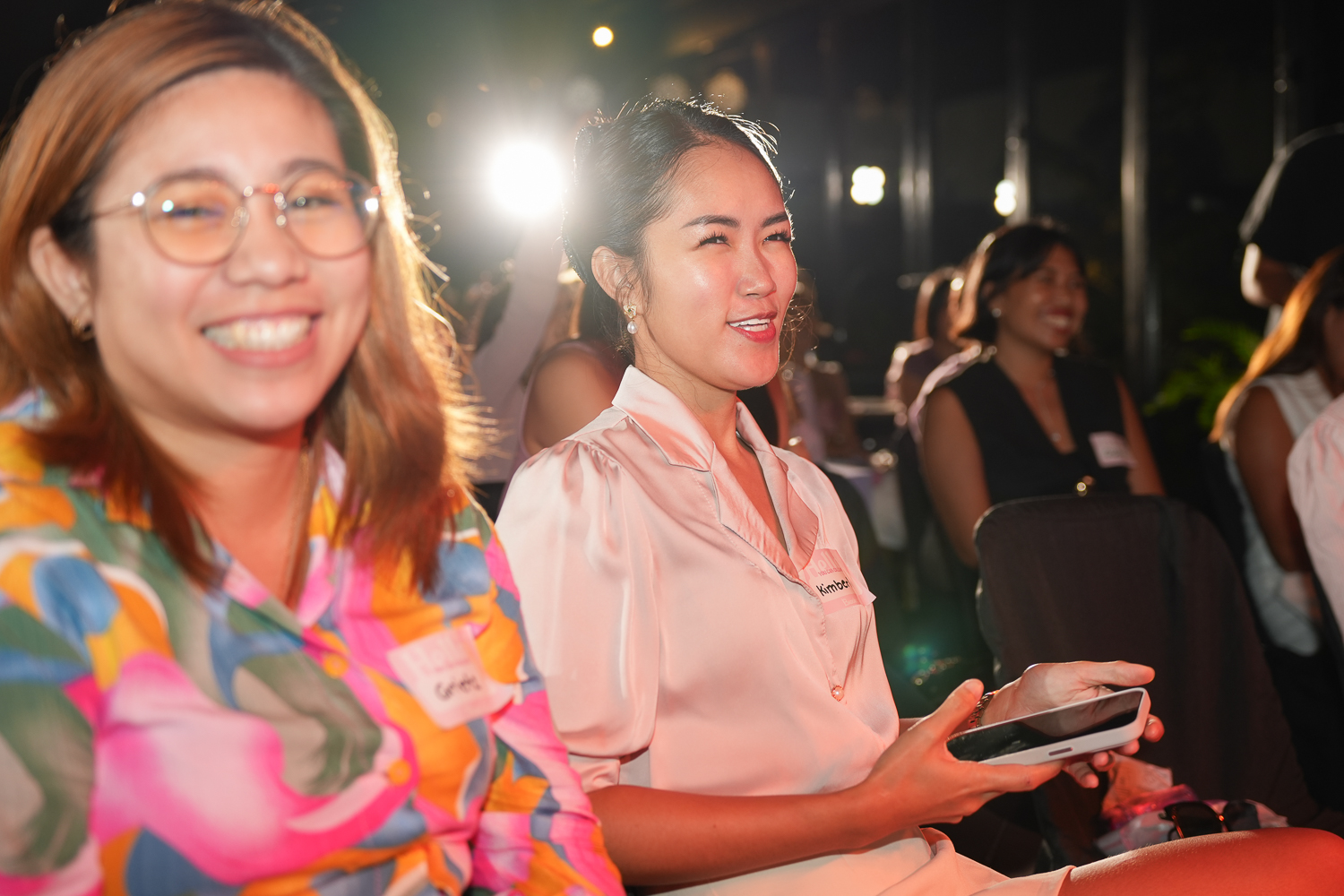 Two attendees smiling together during a break