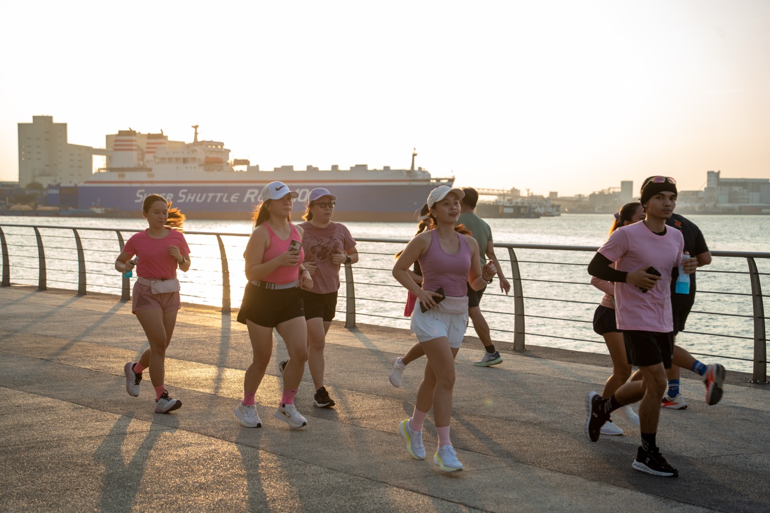 Members running backlit by the morning sun