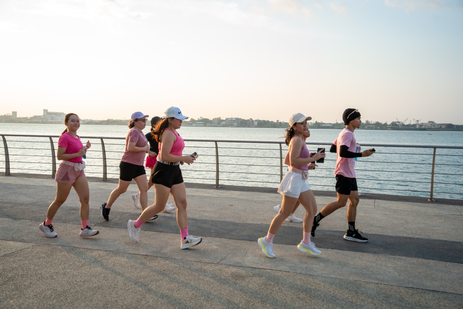 The group running along the promenade in daylight