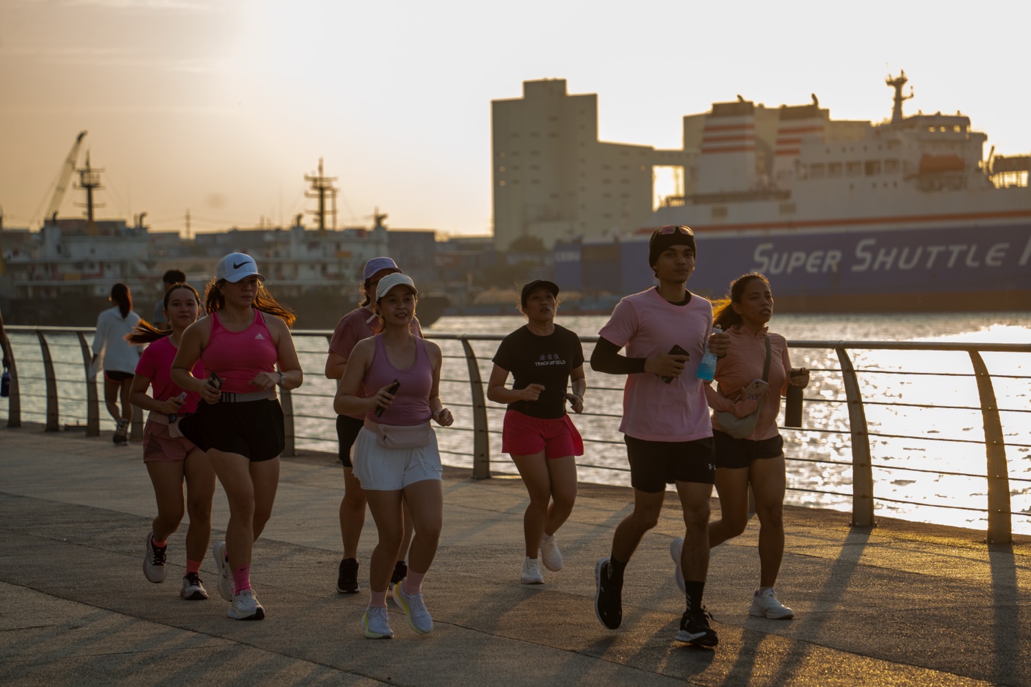 A wide view of the group running along the water