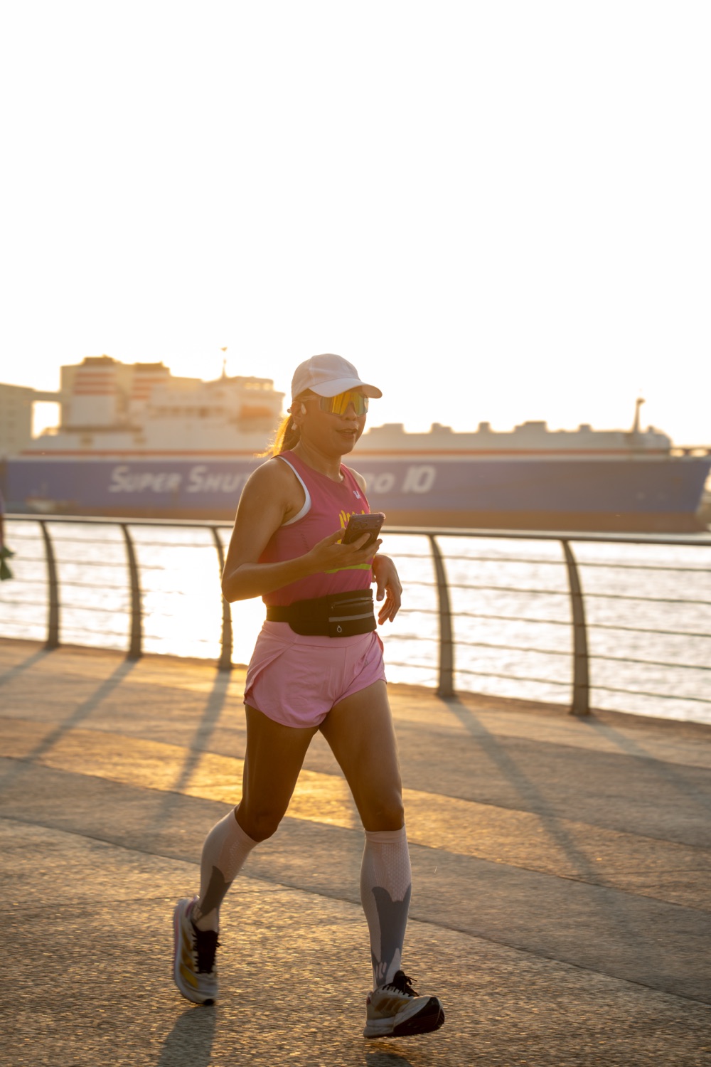 A member running in silhouette against the sunrise