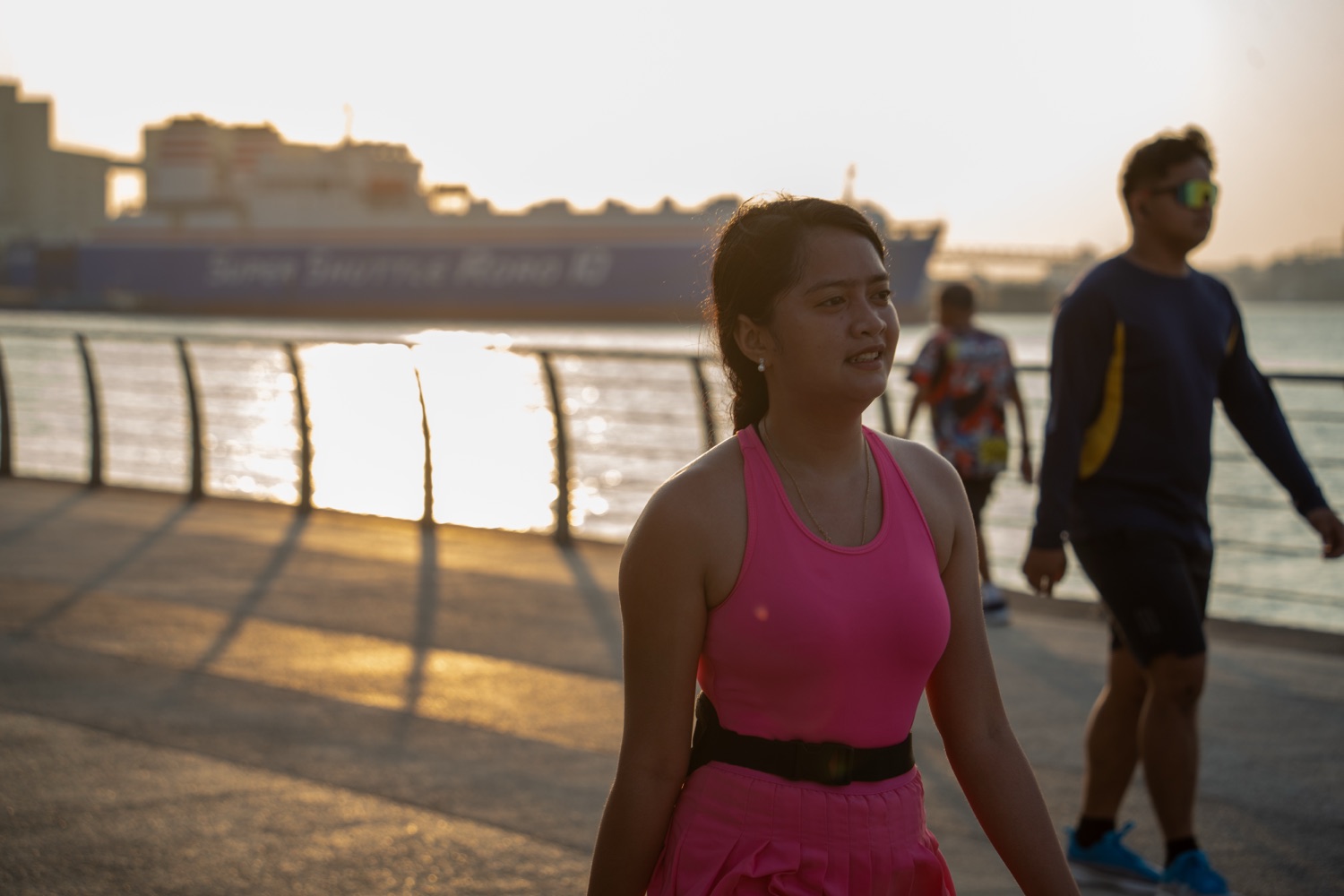 A member in pink running along the promenade