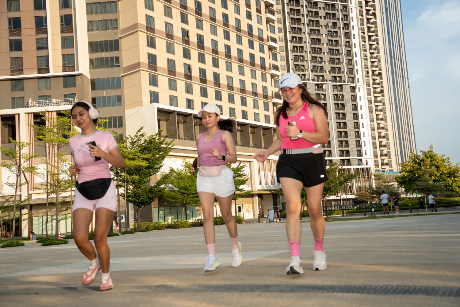 Three members running through the plaza