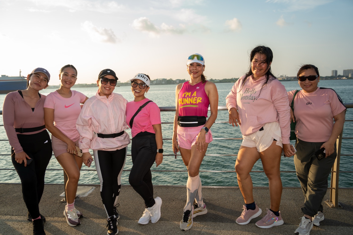 The Run Club posing together by the water