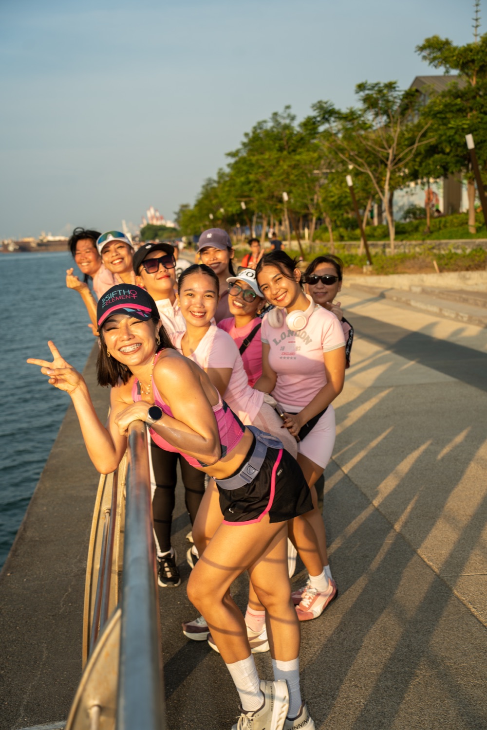 The group lined along the waterfront railing