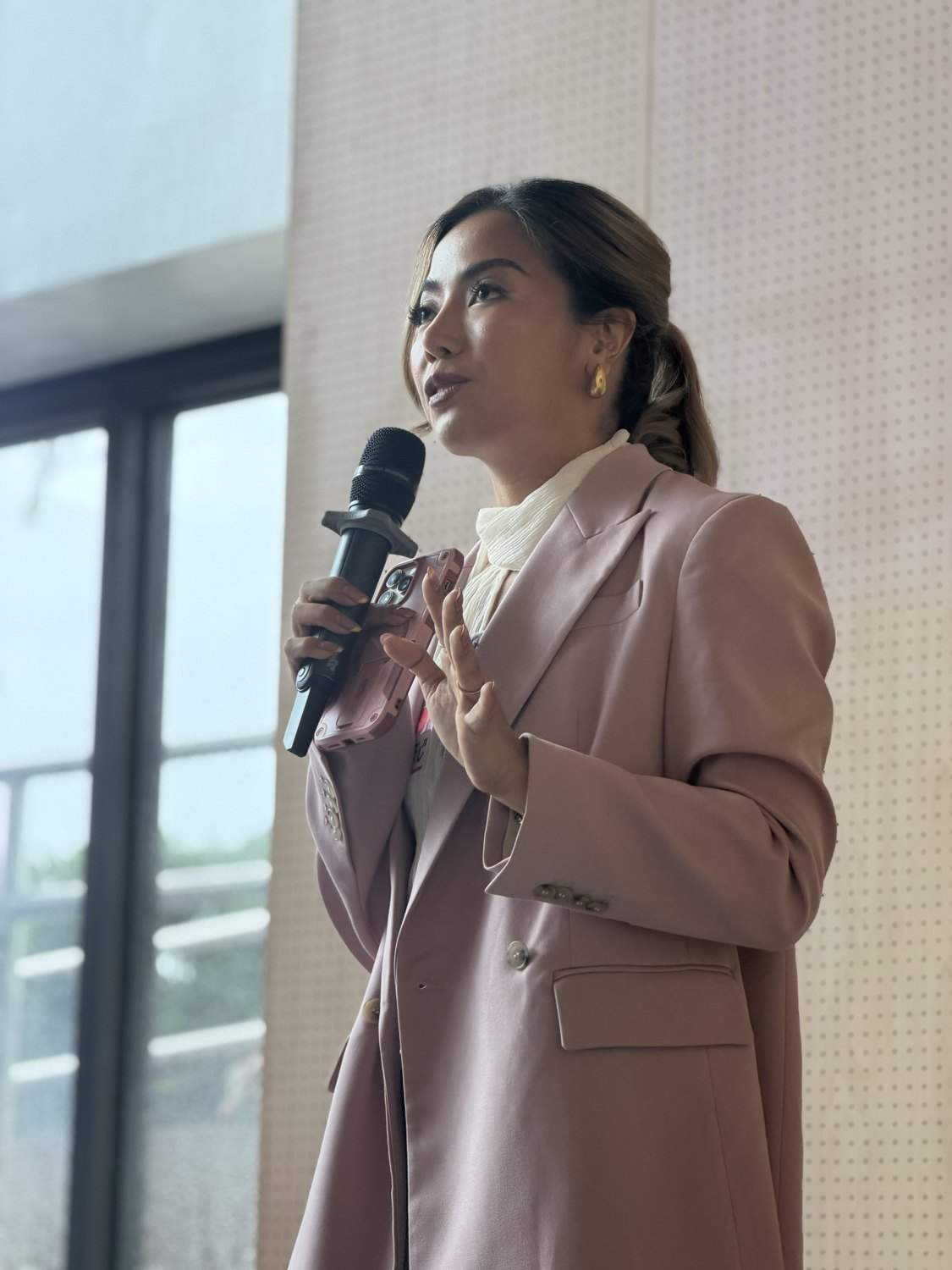 The host speaking into the microphone