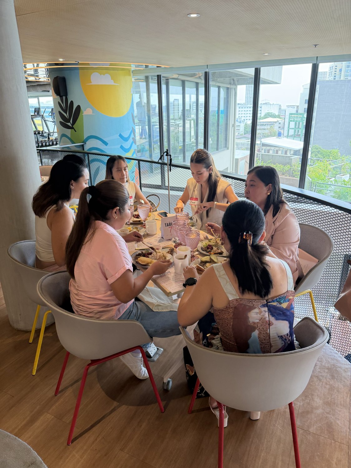 Women in conversation around a round breakfast table