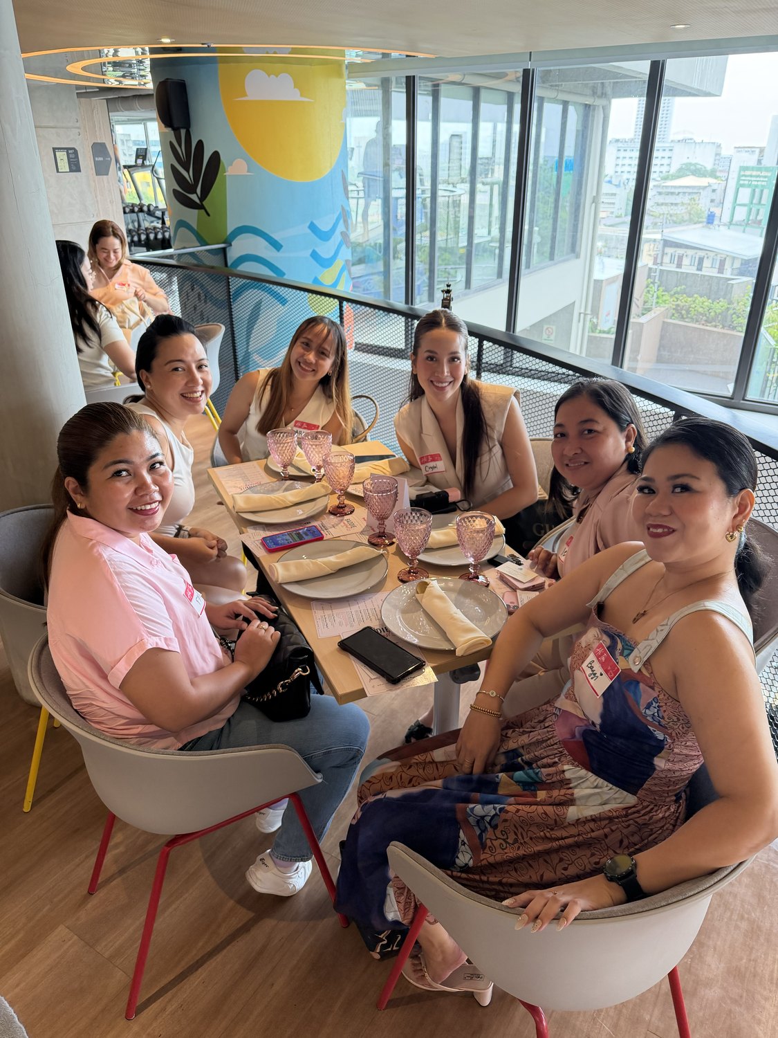 A table of women laughing over breakfast