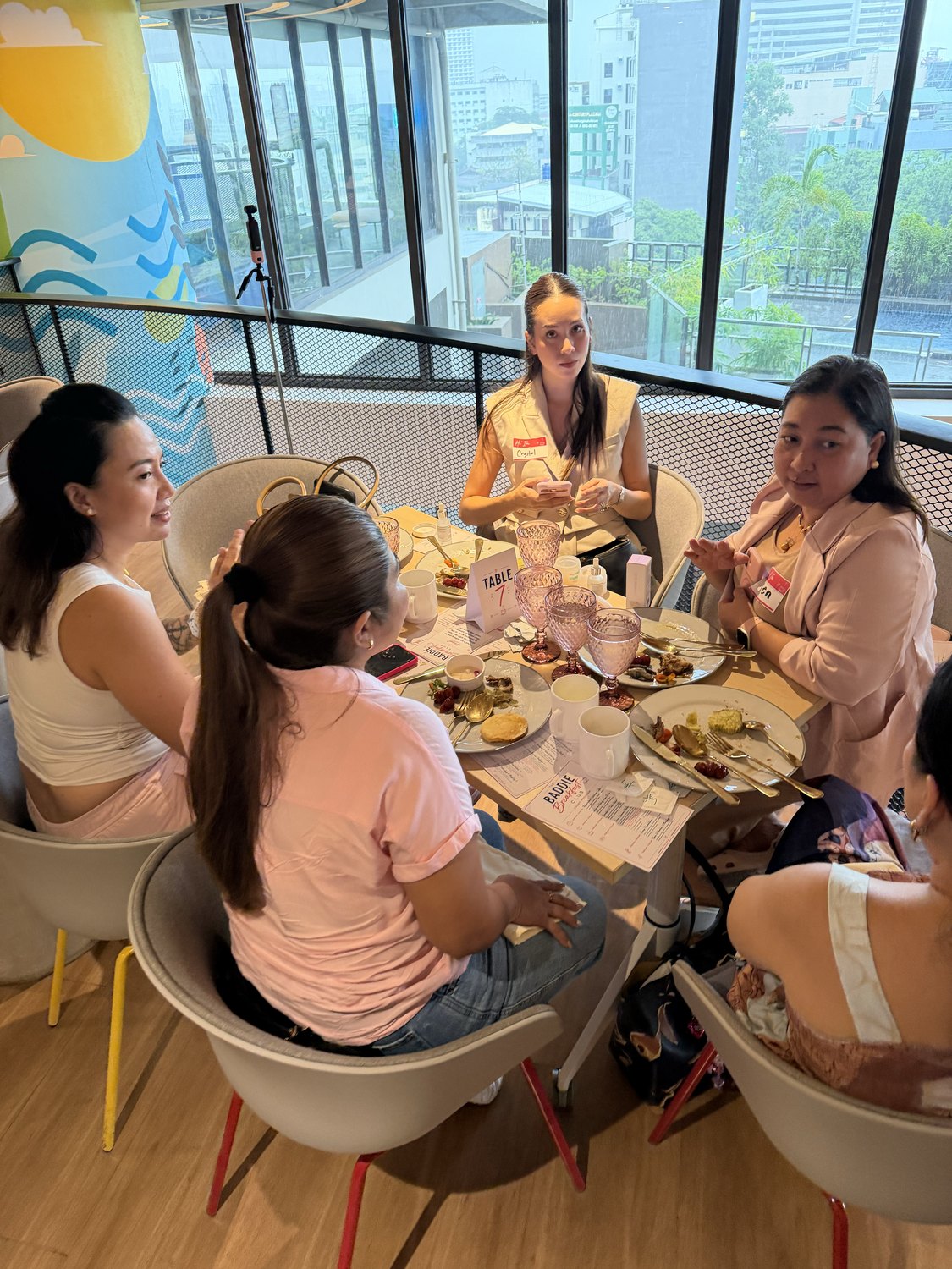 Women talking around a breakfast table at Baddie Breakfast Club