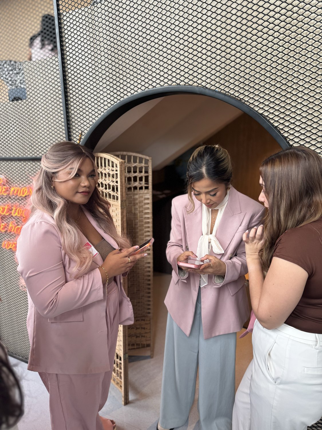 Three women talking by the arch at Baddie Breakfast Club