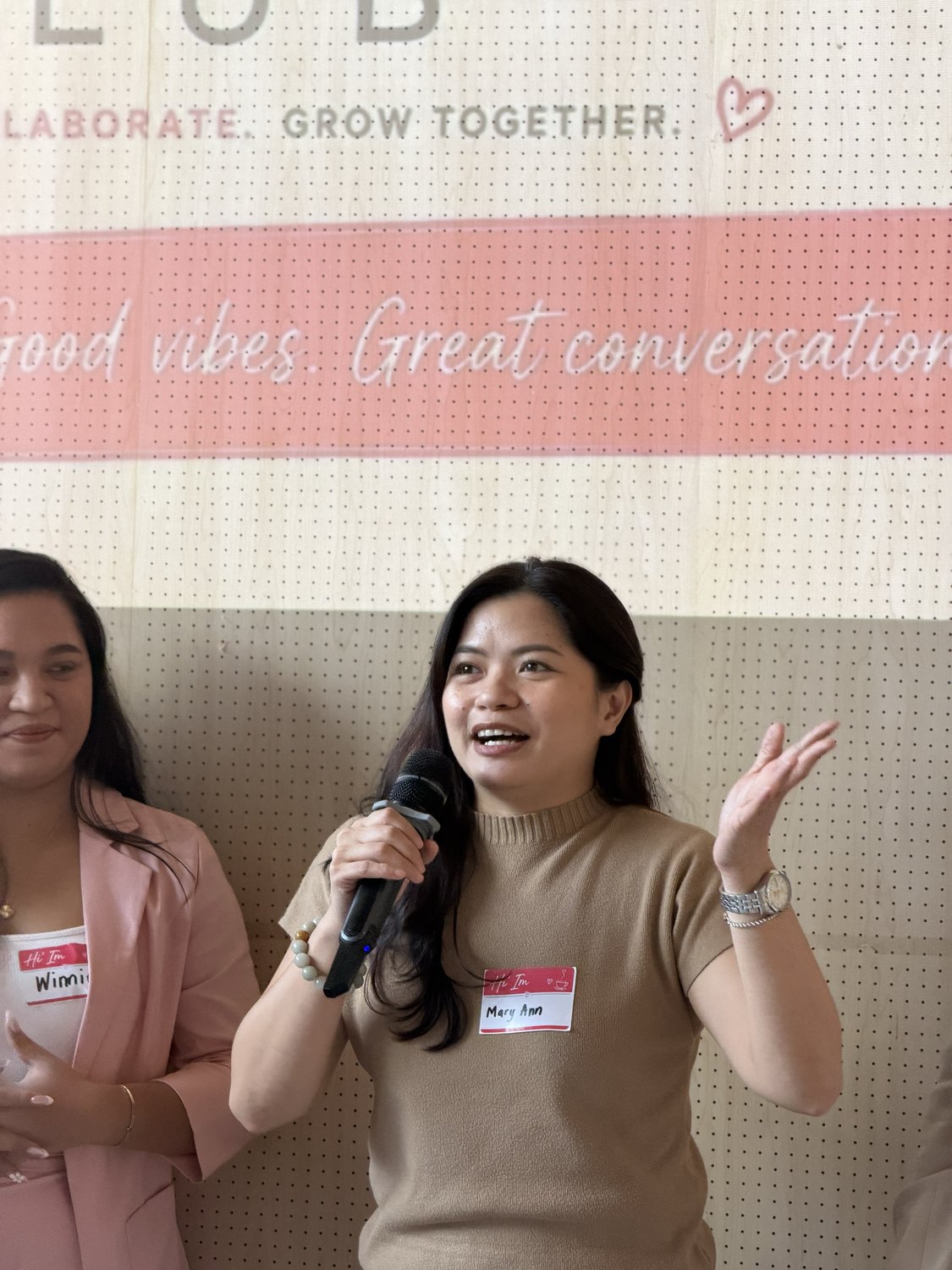 A guest speaking with her hand raised