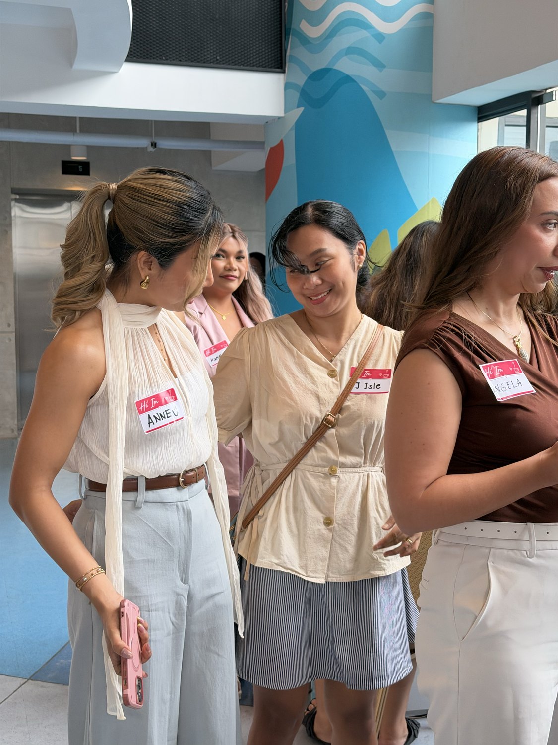 Three women mingling at Baddie Breakfast Club