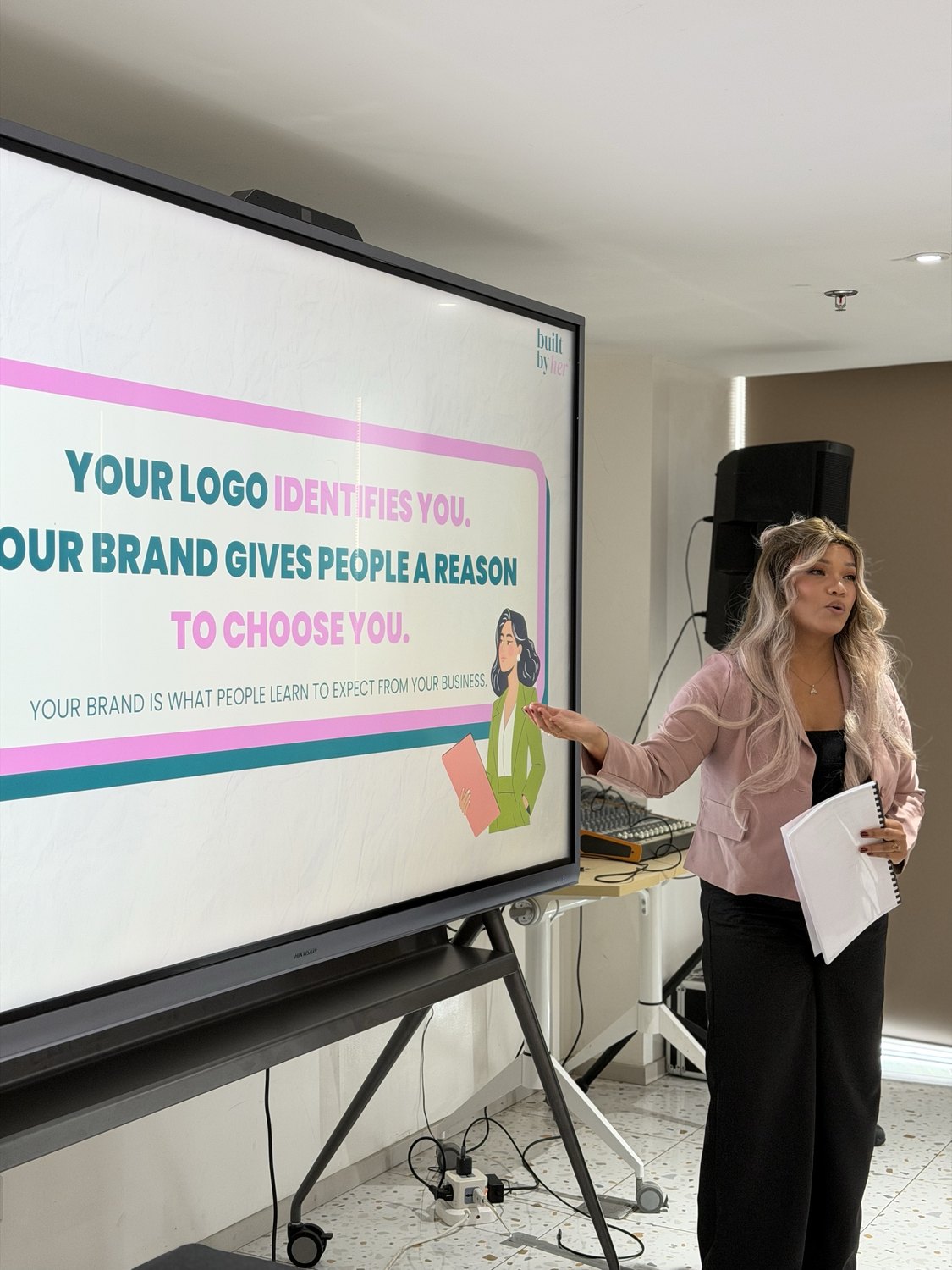 A facilitator presenting the slide on logo and brand