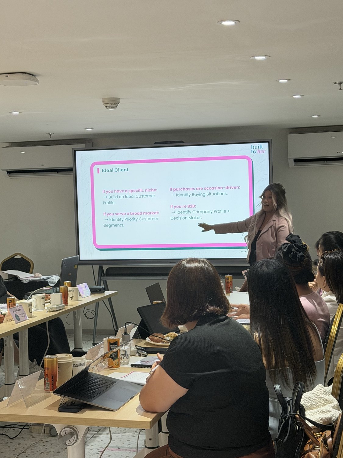 A facilitator pointing to the worksheet on screen