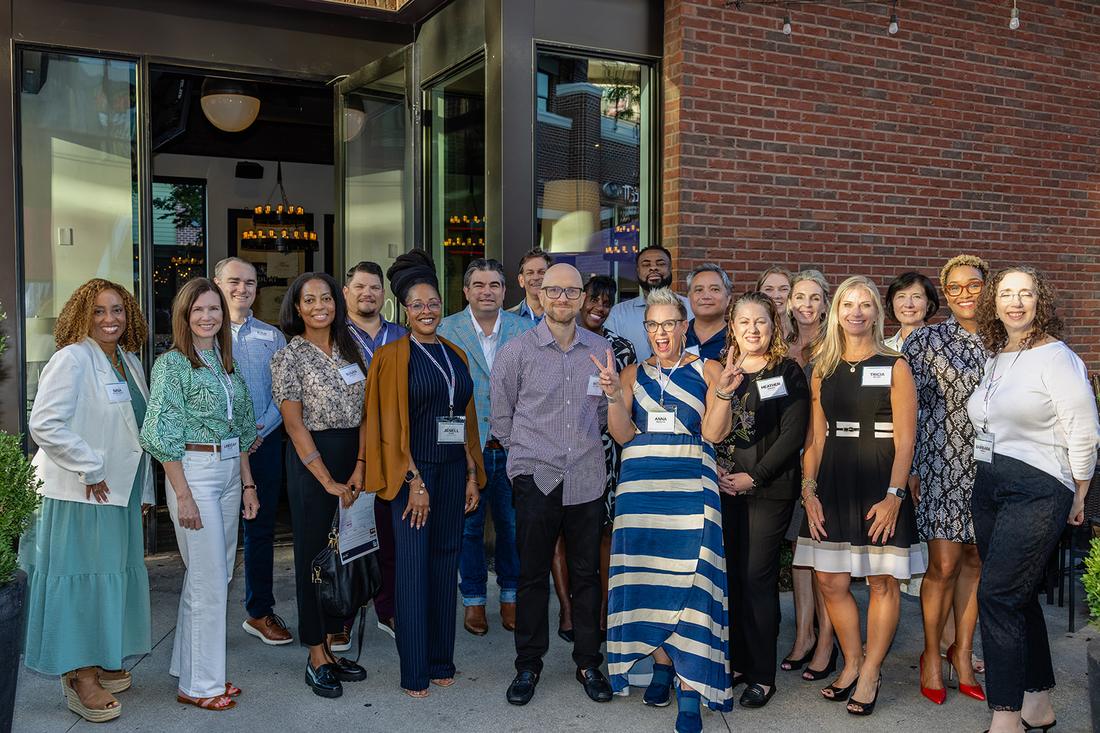 The full guest list of the Atlanta table, photographed together outside the restaurant.