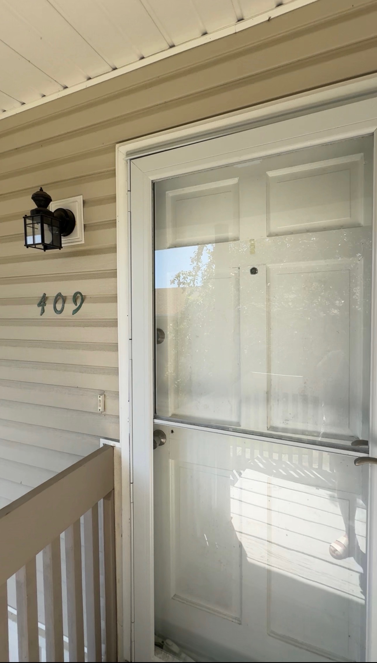 Front door of Unit 409 with the unit number on the siding
