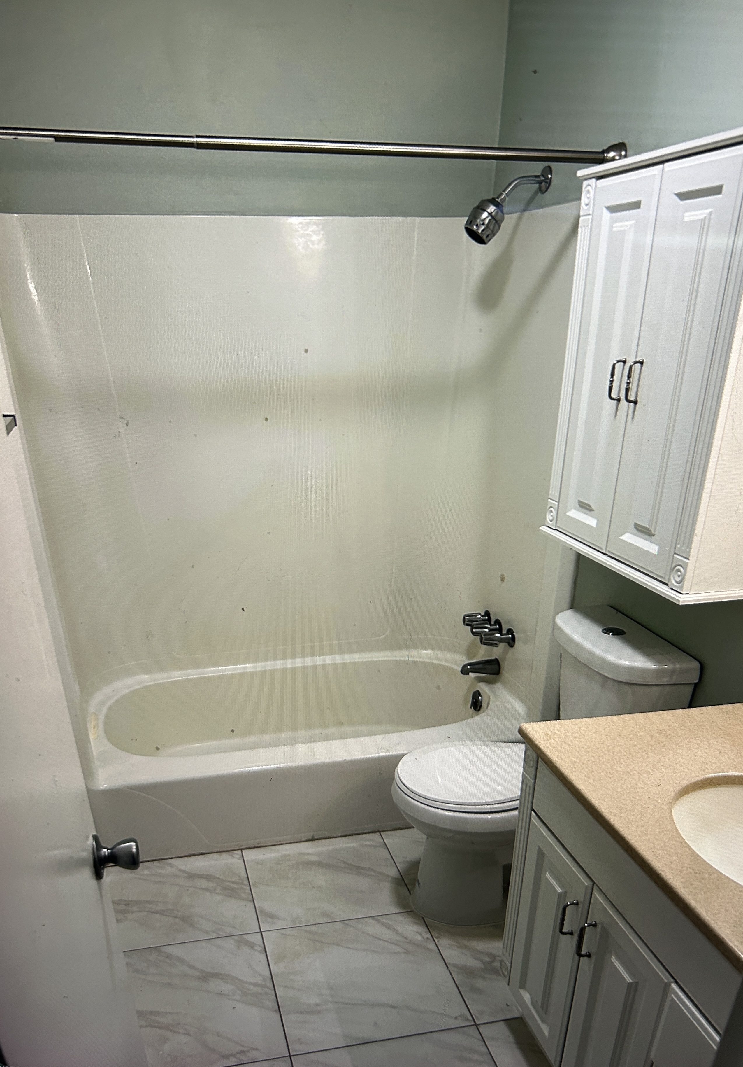 Bathroom with tub, shower, and white vanity