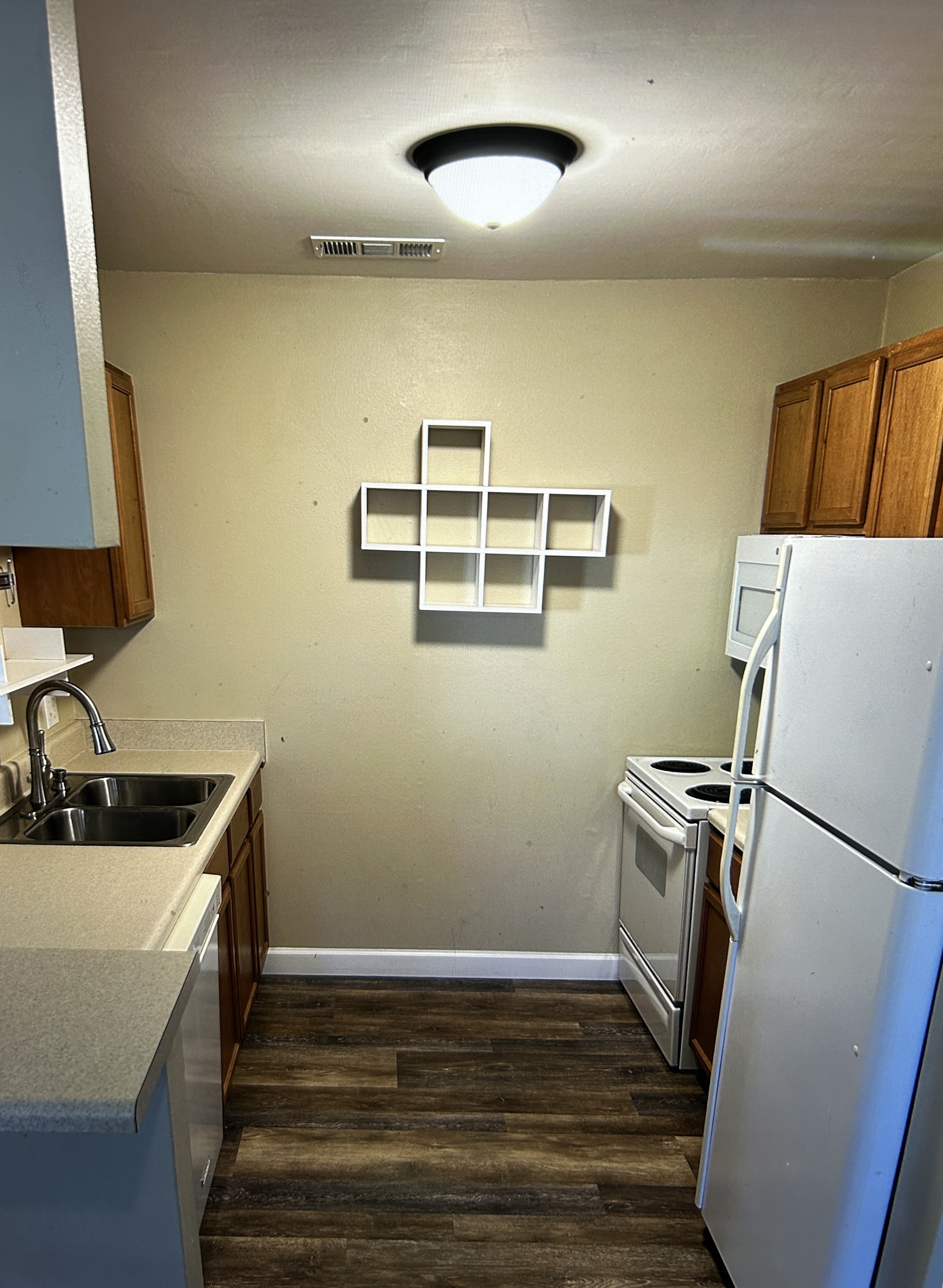 Kitchen with white appliances and wood cabinets